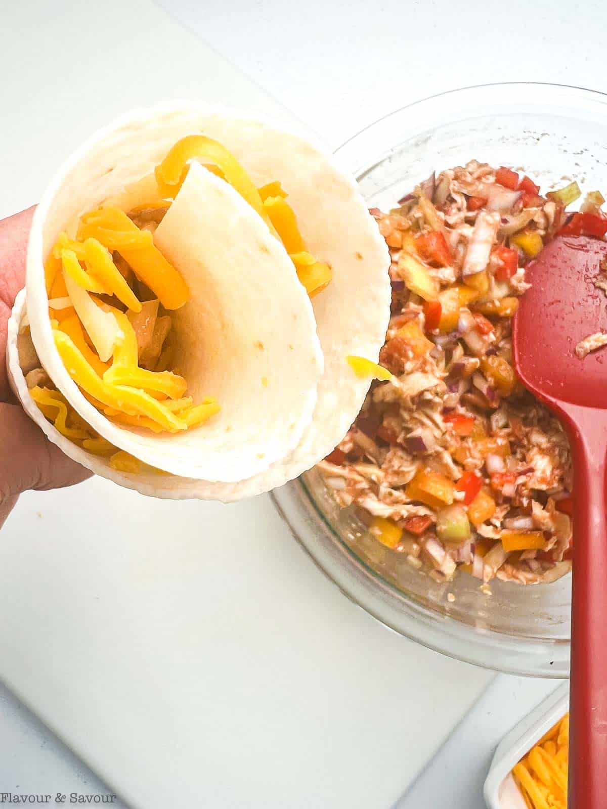 Close up view of a rolled filled tortilla cone to make a blooming quesadilla ring.