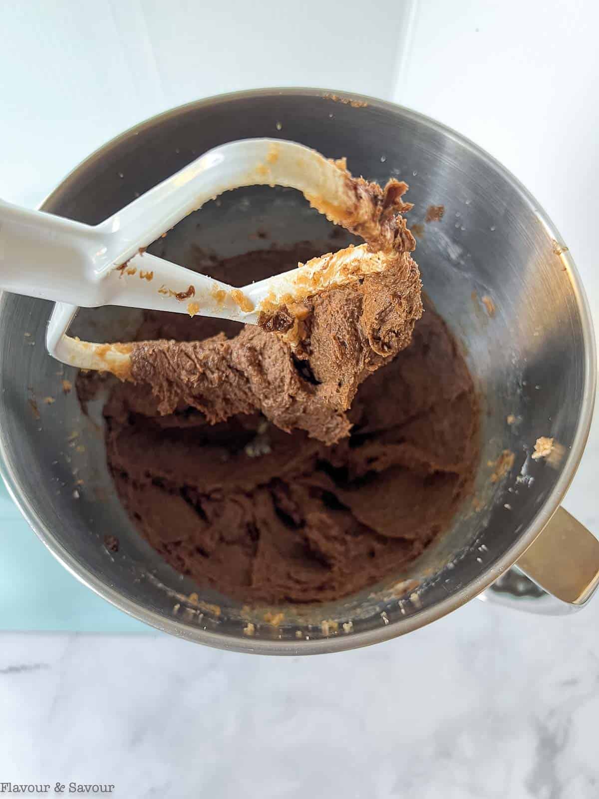 Gluten-free chewy coffee cookie dough in the mixing bowl of a stand mixer.