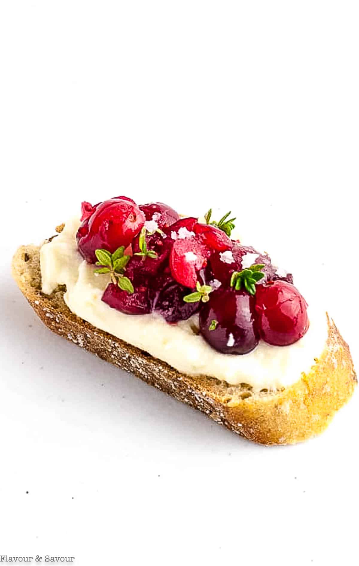 Close up overhead view of a cranberry whipped ricotta crostini appetizer.