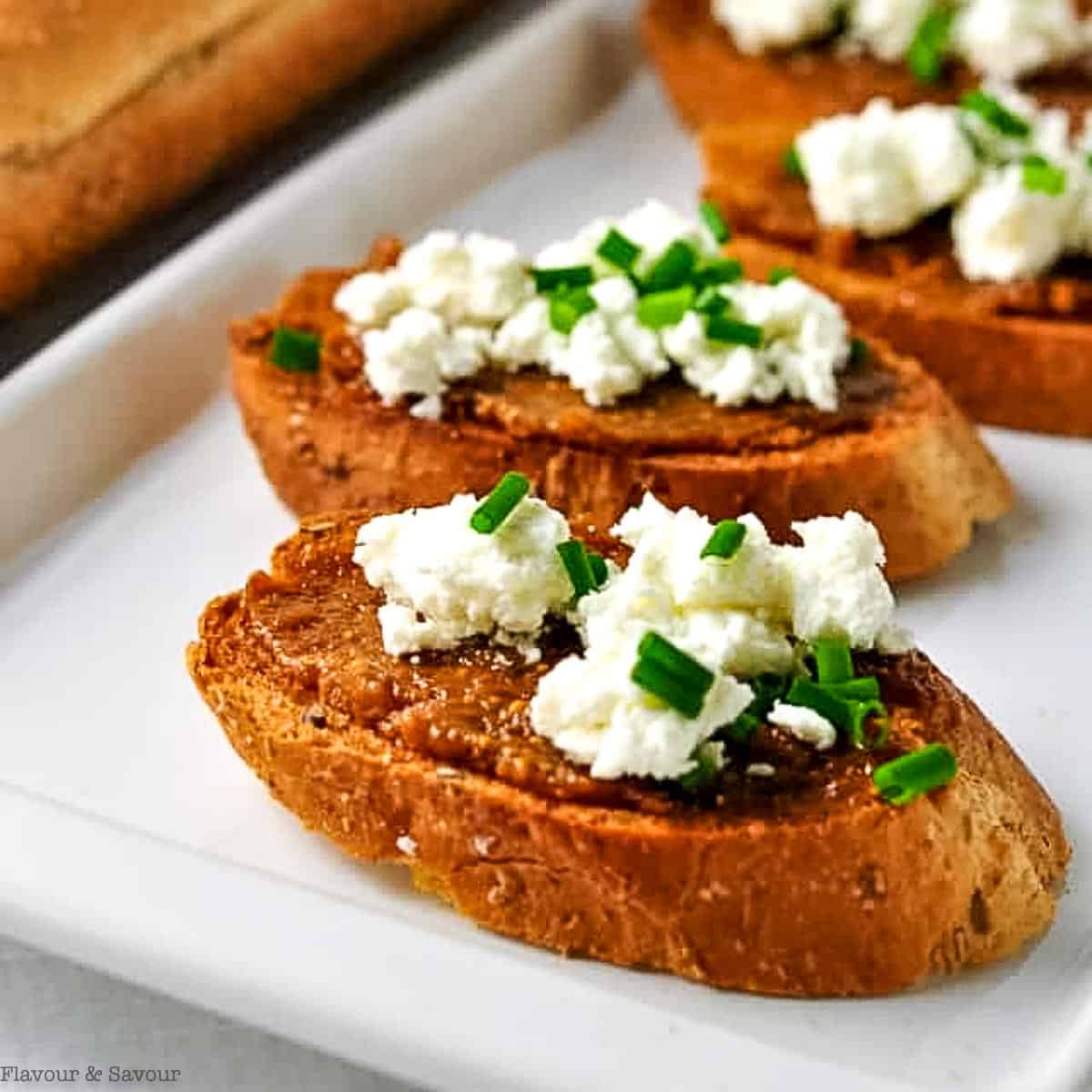 Crostini appetizers topped with fig compote and goat cheese.