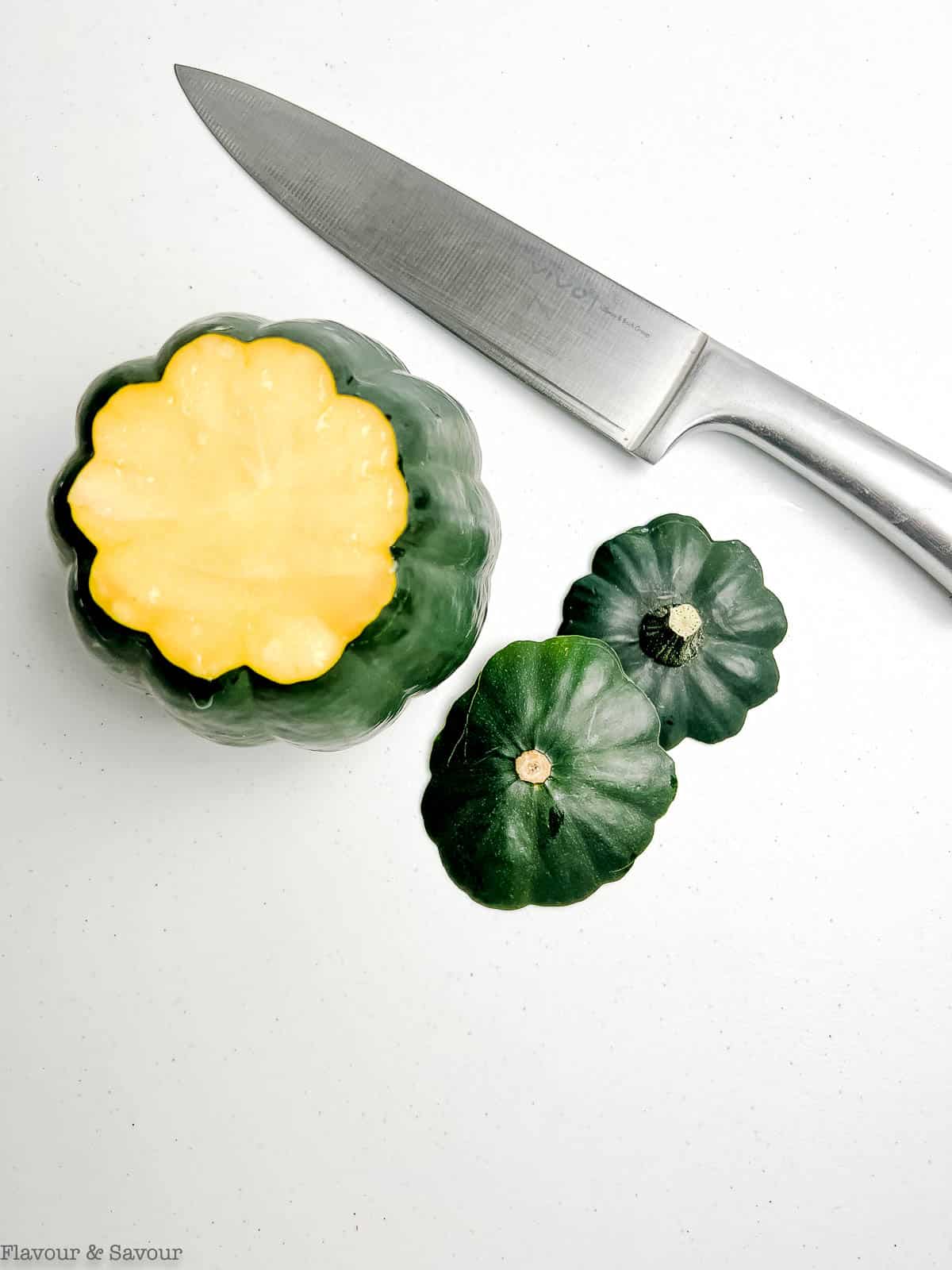 An acorn squash with the ends sliced off.