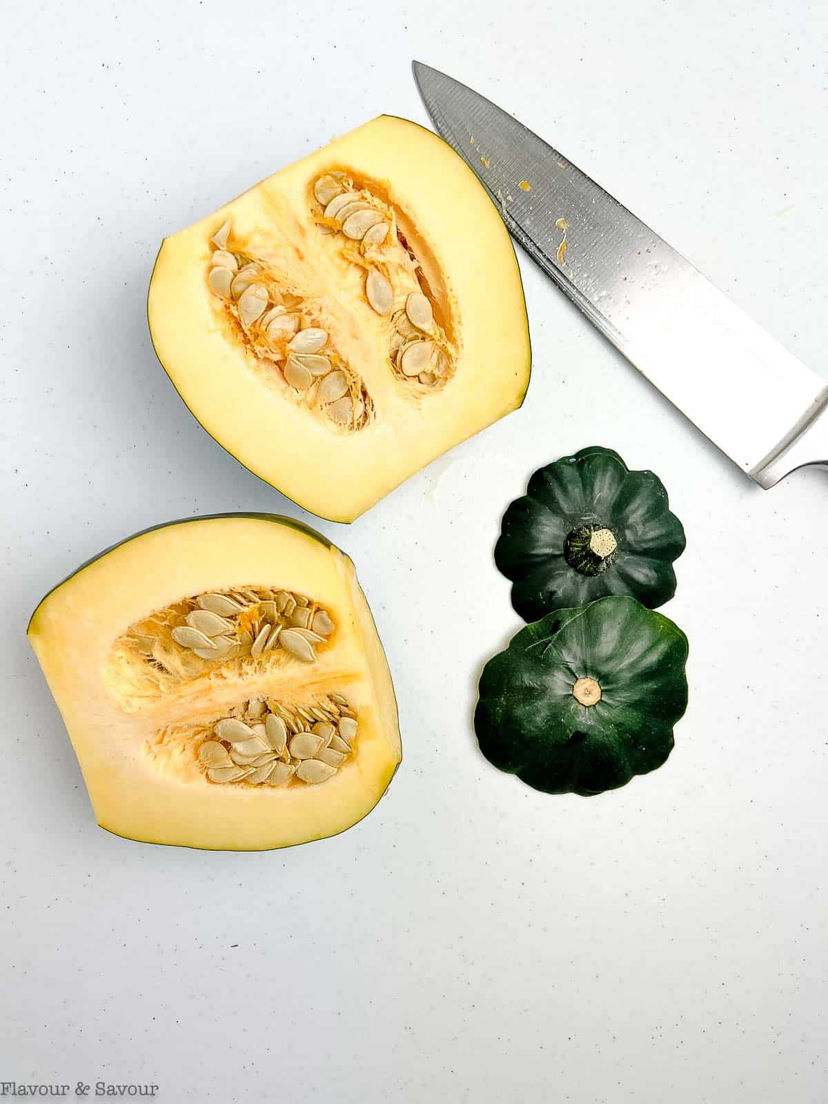 An acorn squash sliced in half, showing the seeds.