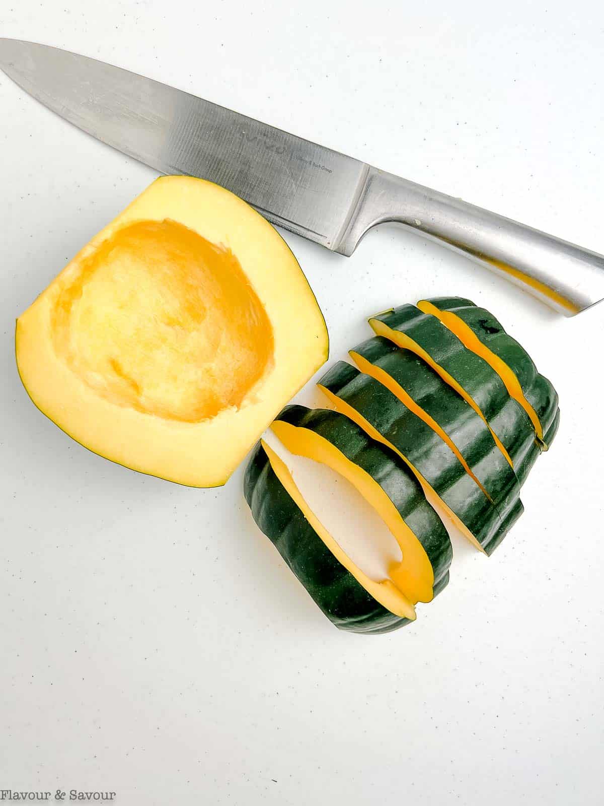 An acorn squash cut into slices.