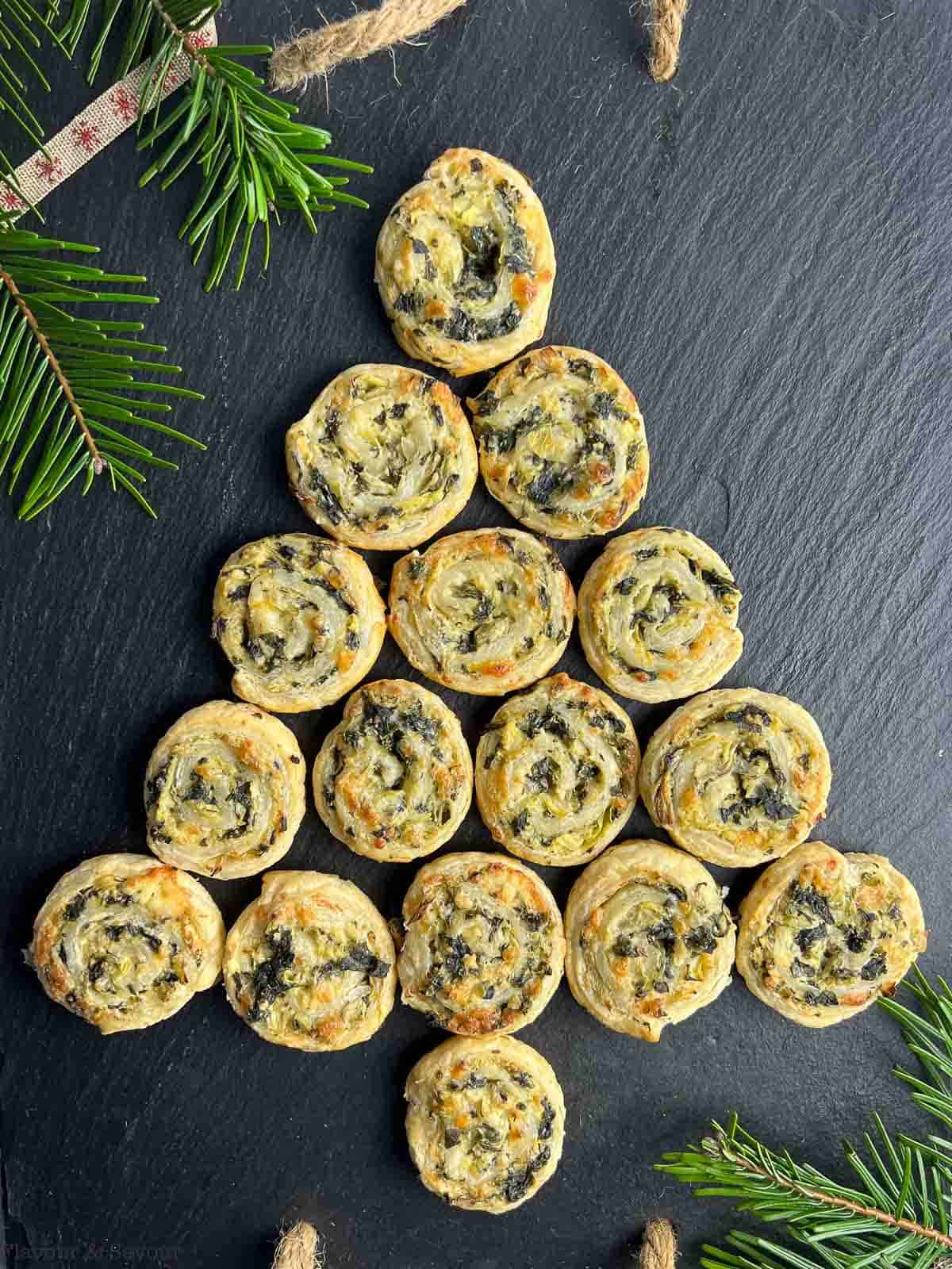 Puff Pastry Spinach Artichoke Pinwheels arranged in the shape of a Christmas tree.