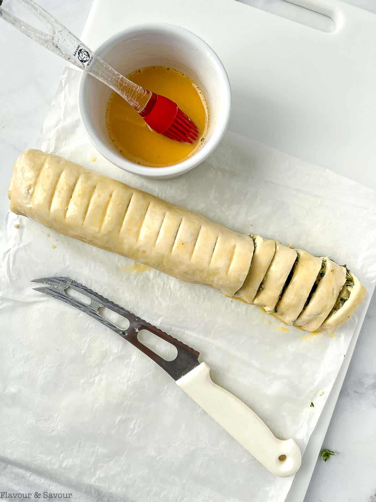 Sliced log of puff pastry spinach swirls.