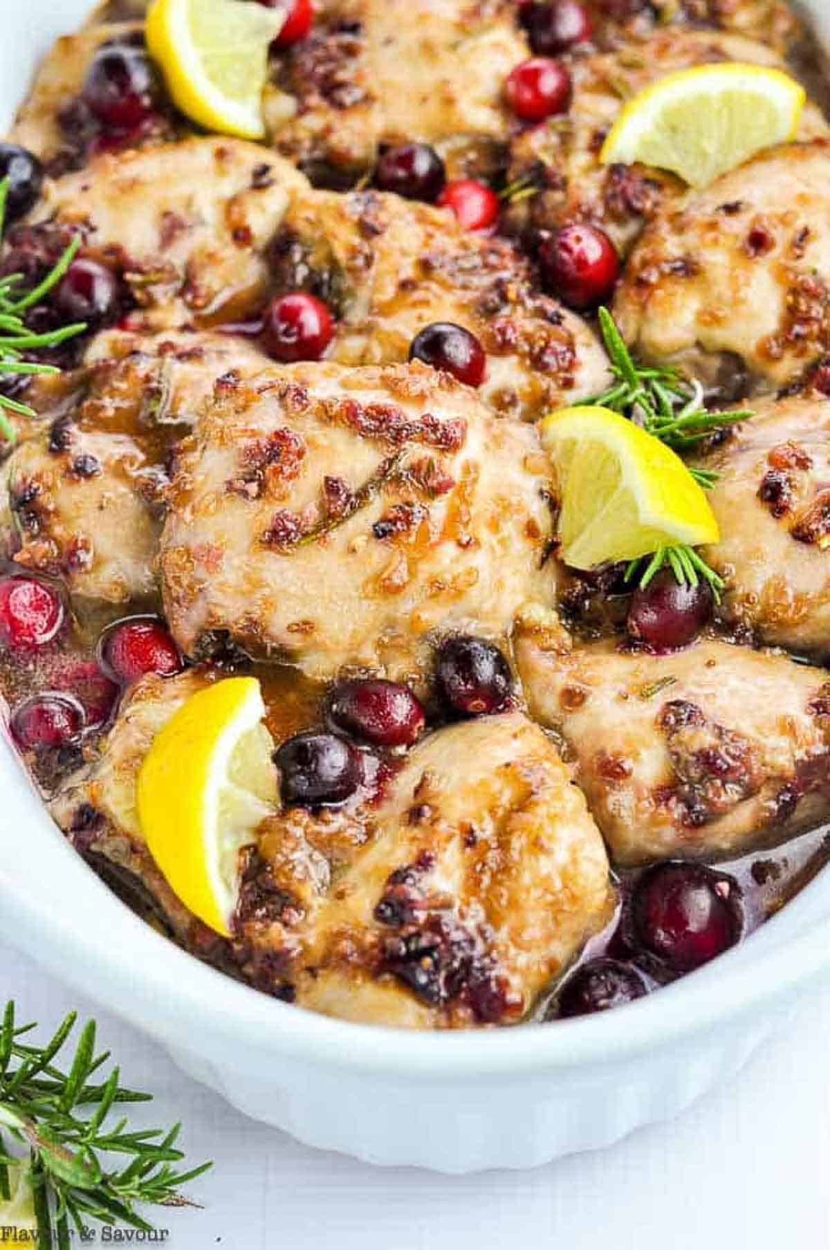 Close up view of cranberry chicken with rosemary and lemon.