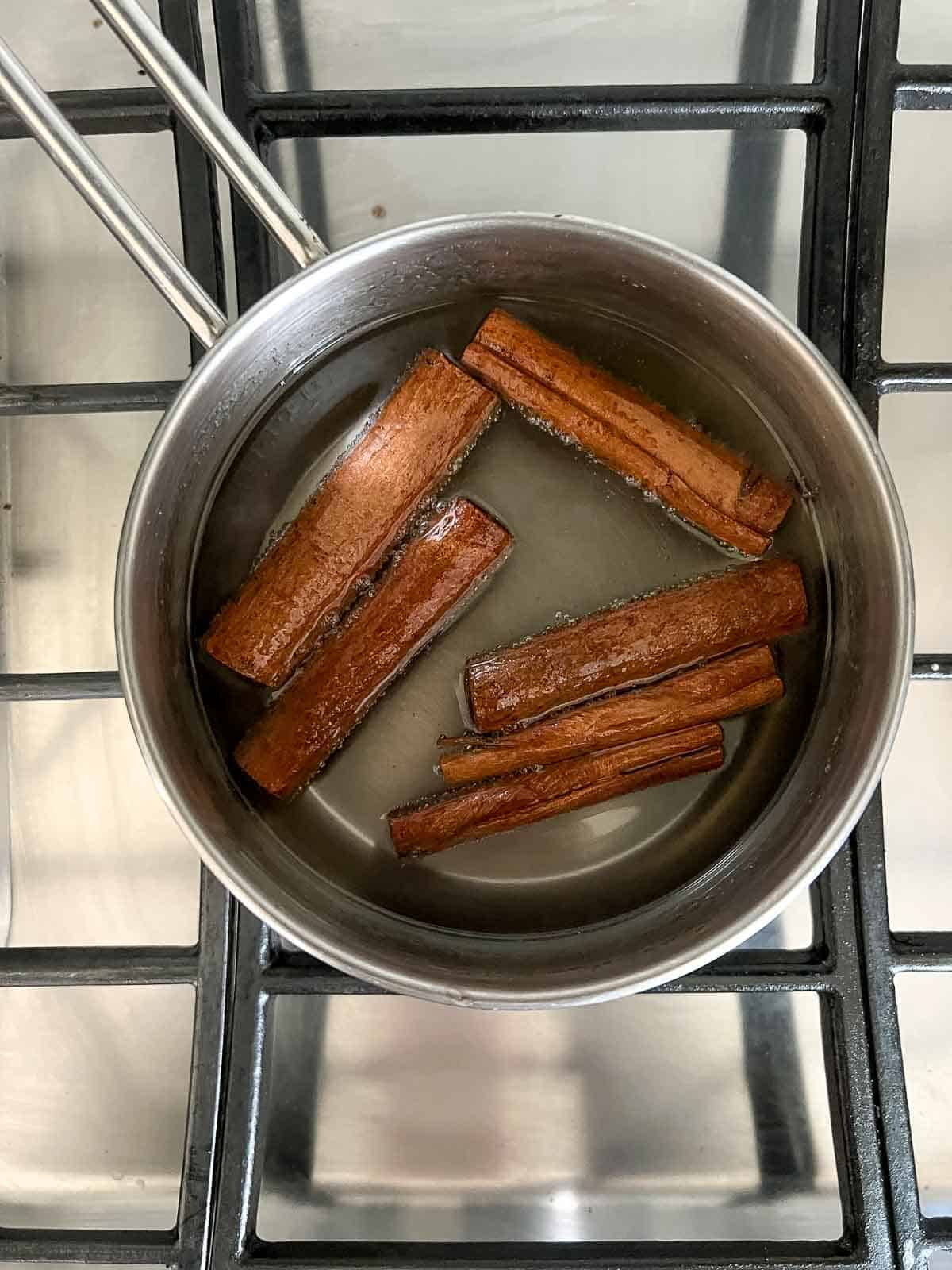 Cinnamon sticks added to a sugar and water syrup.