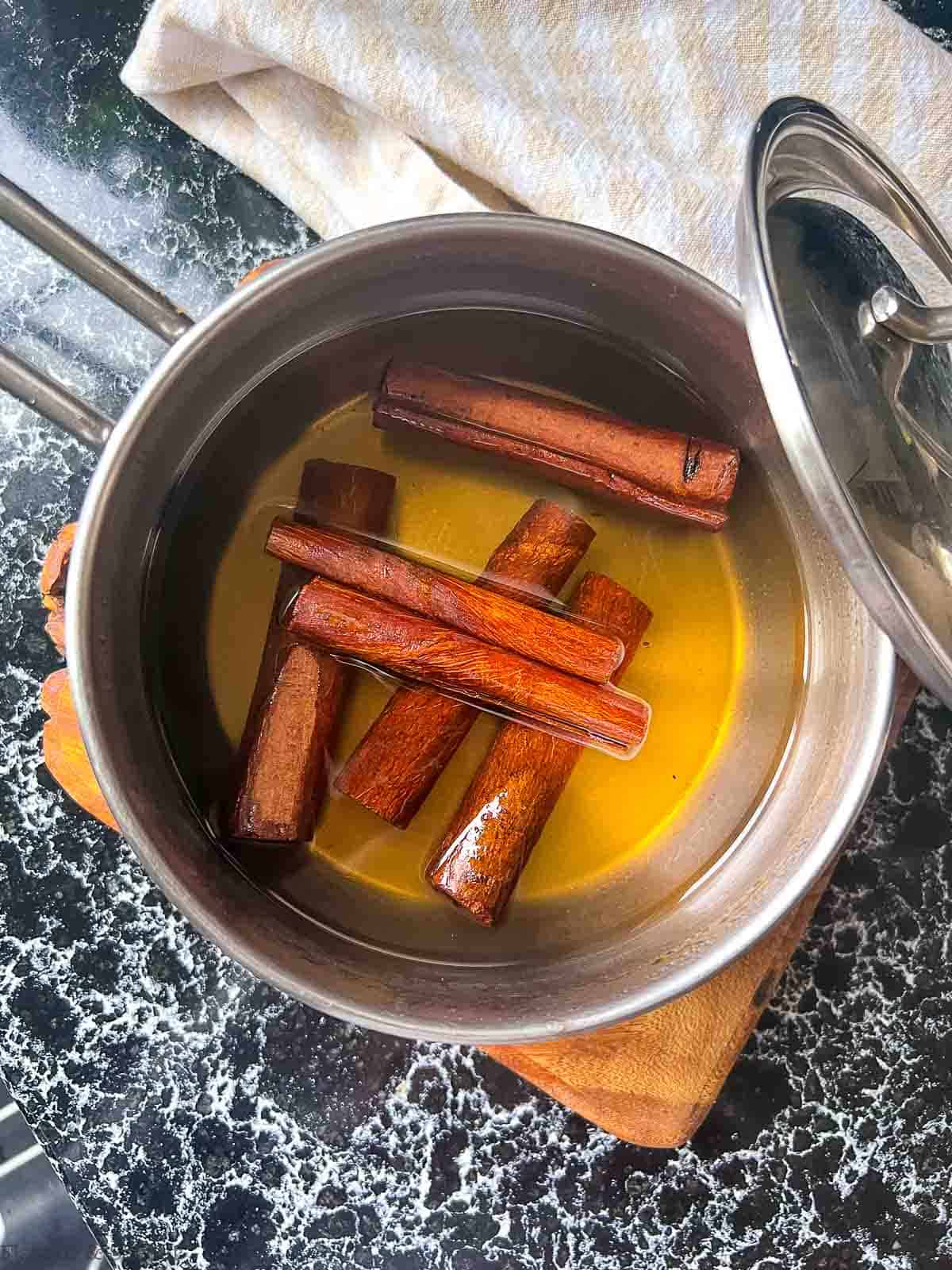 Cinnamon sticks soaking in simple sugar syrup.