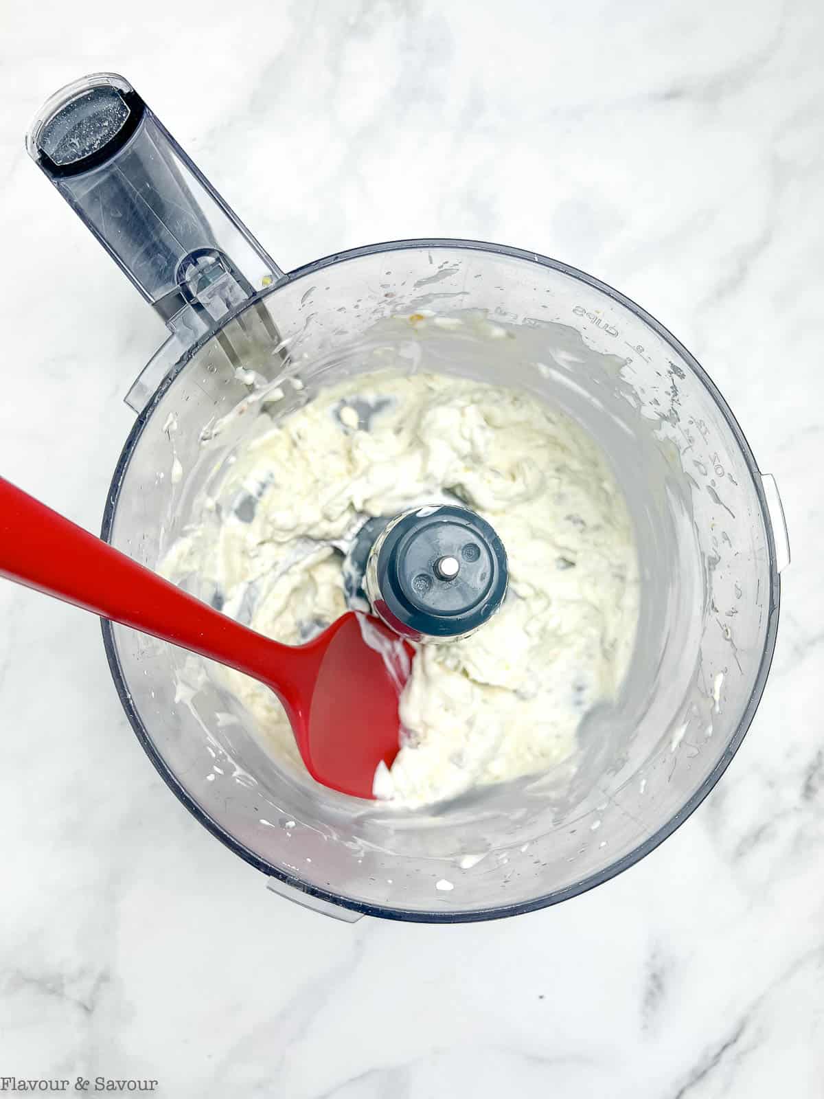 Combining ingredients for smoked salmon dip in a food processor.