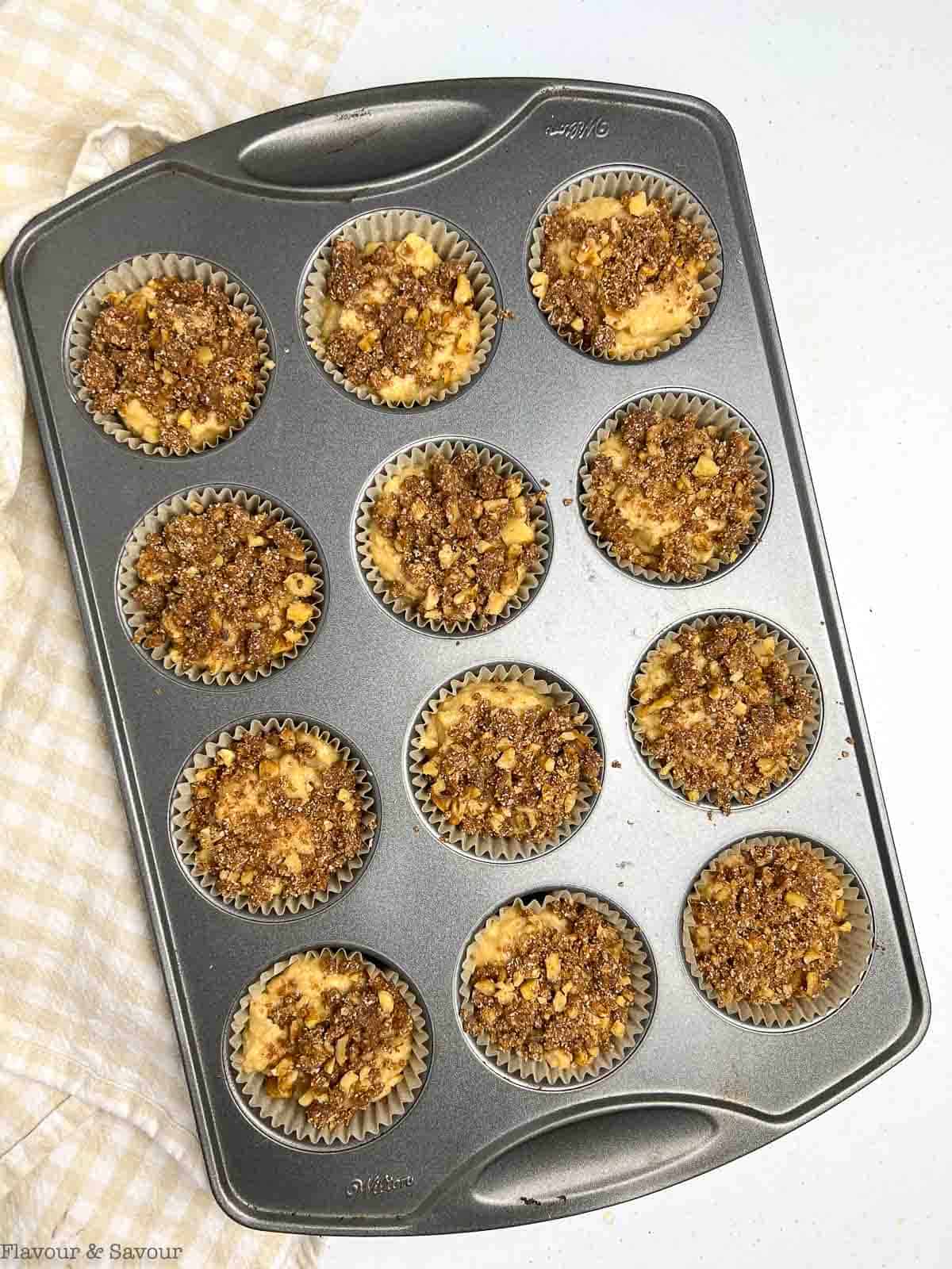 Banana Streusel muffins in a muffin tin ready to bake.