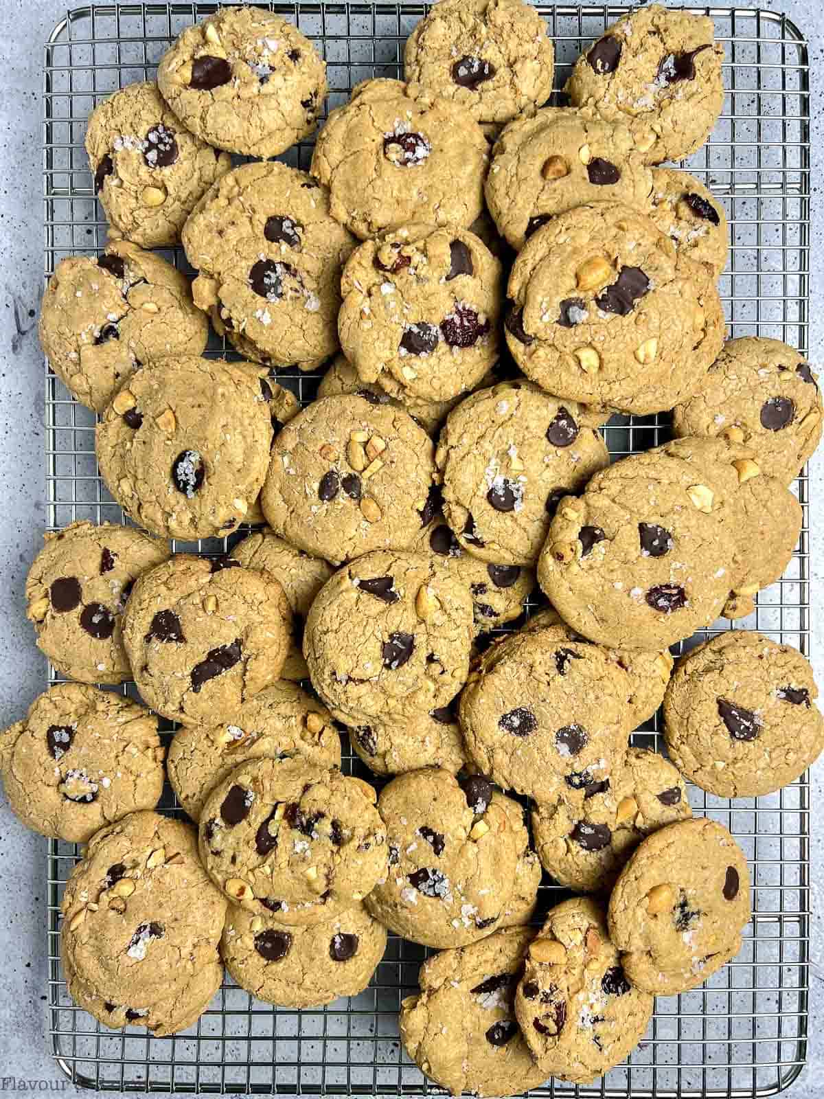 A large batch of kitchen sink cookies on a wire cooling rack.