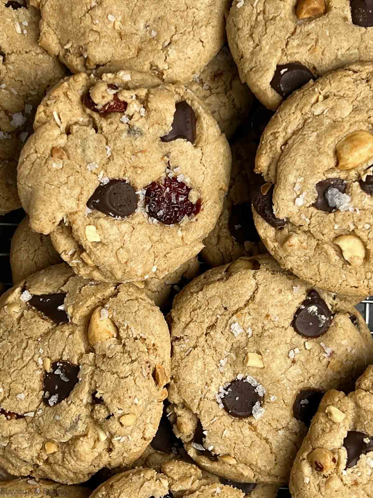Close up view of gluten-free Kitchen Sink Cookies with chocolate chips, peanuts, raisins and dried cranberries.