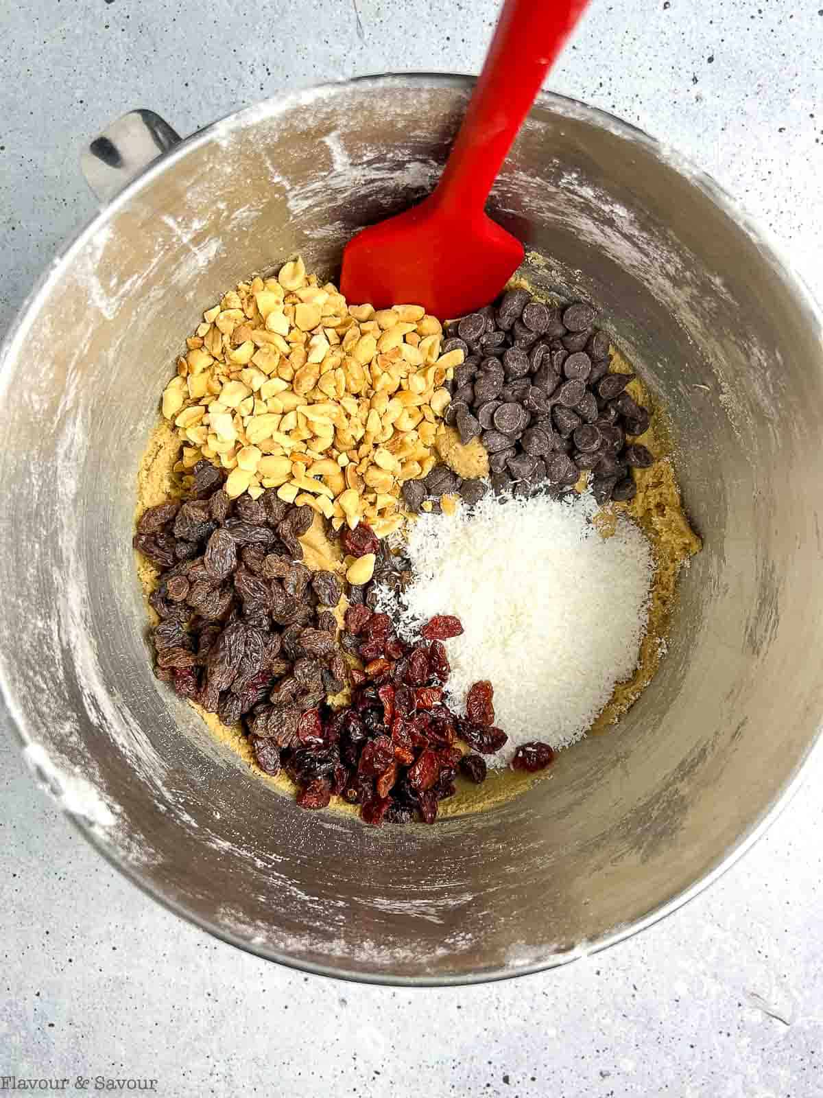 Gluten-free Kitchen Sink Cookie dough with optional mix-ins in a stainless steel bowl.