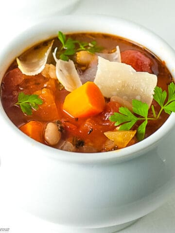 Close up view of a bowl of Slow Cooker Tuscan Minestrone Soup.