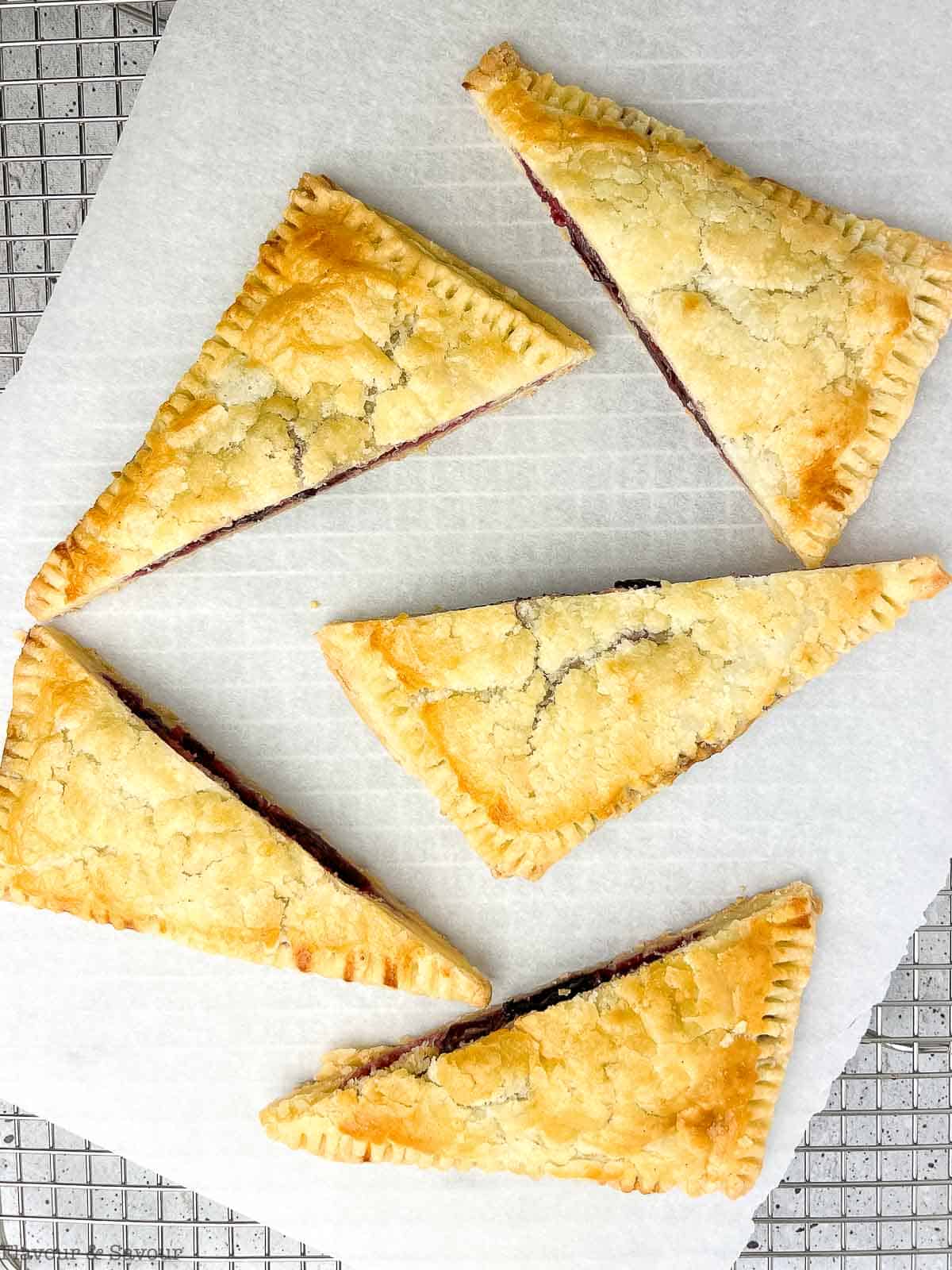 Overhead view of cherry hand pies sliced in half on the diagonal.