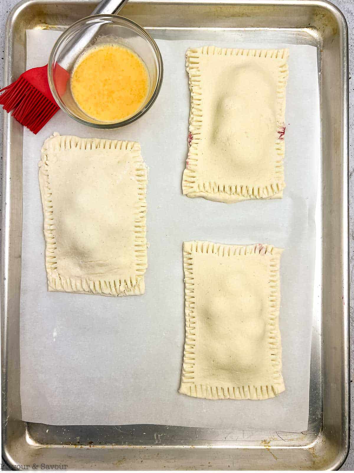 Cherry hand pies on baking sheet