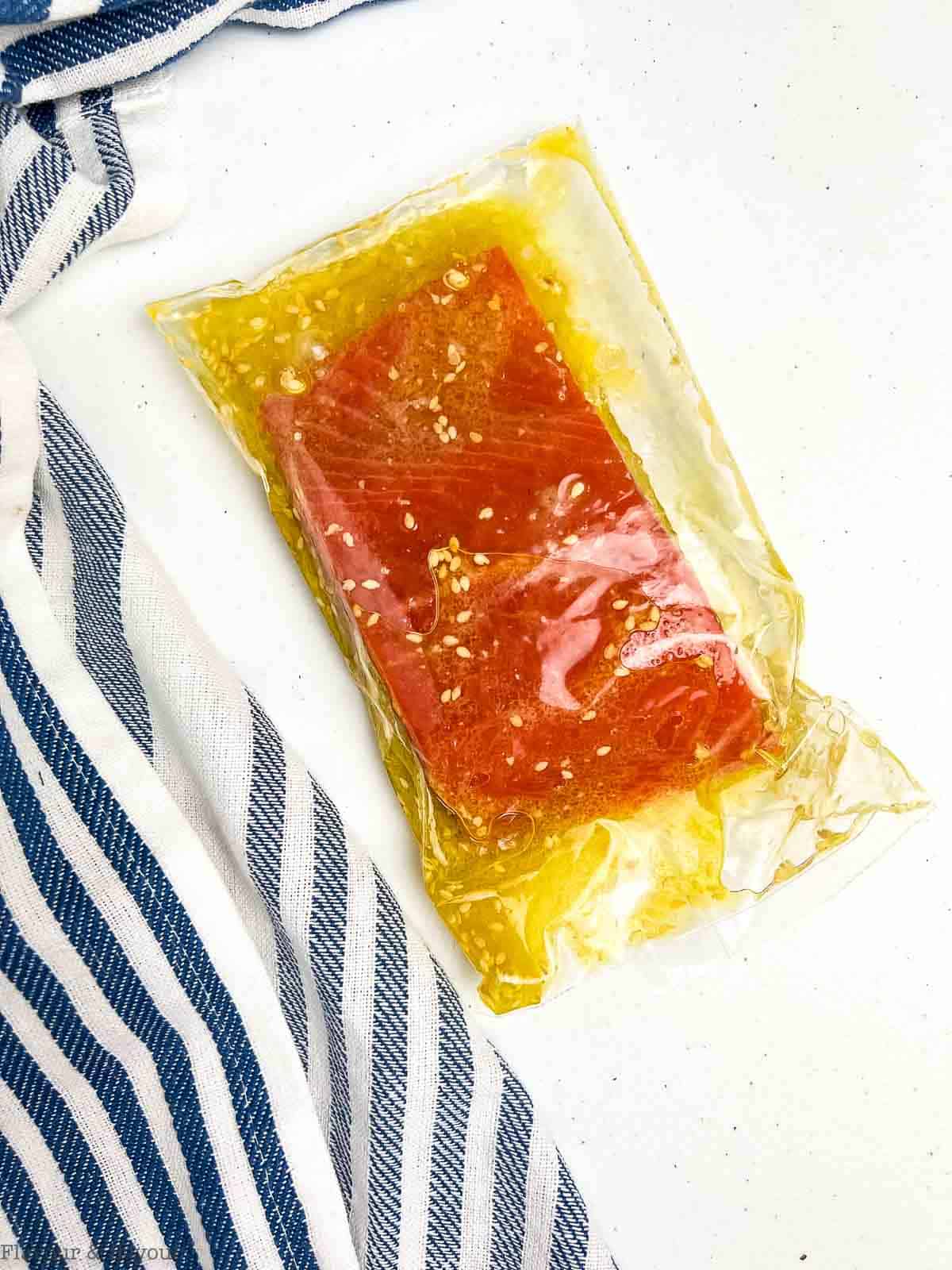 A salmon fillet marinating in sesame miso marinade.