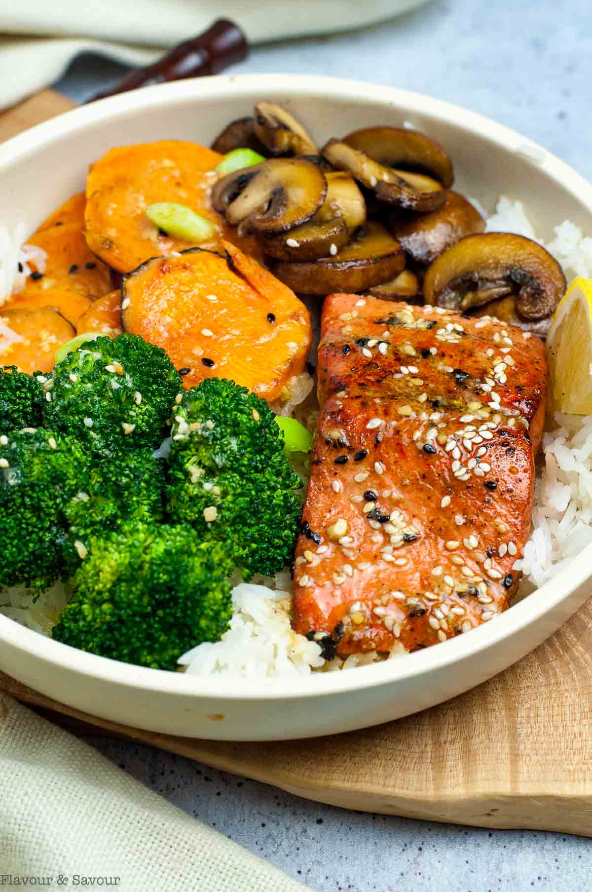 A power bowl with sesame miso salmon, mushrooms, sweet potatoes, broccoli, and rice.