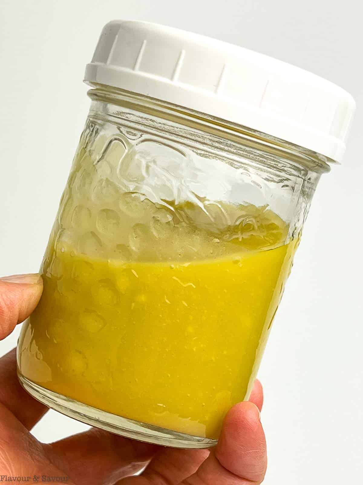 Honey-Dijon dressing in a small Mason jar.