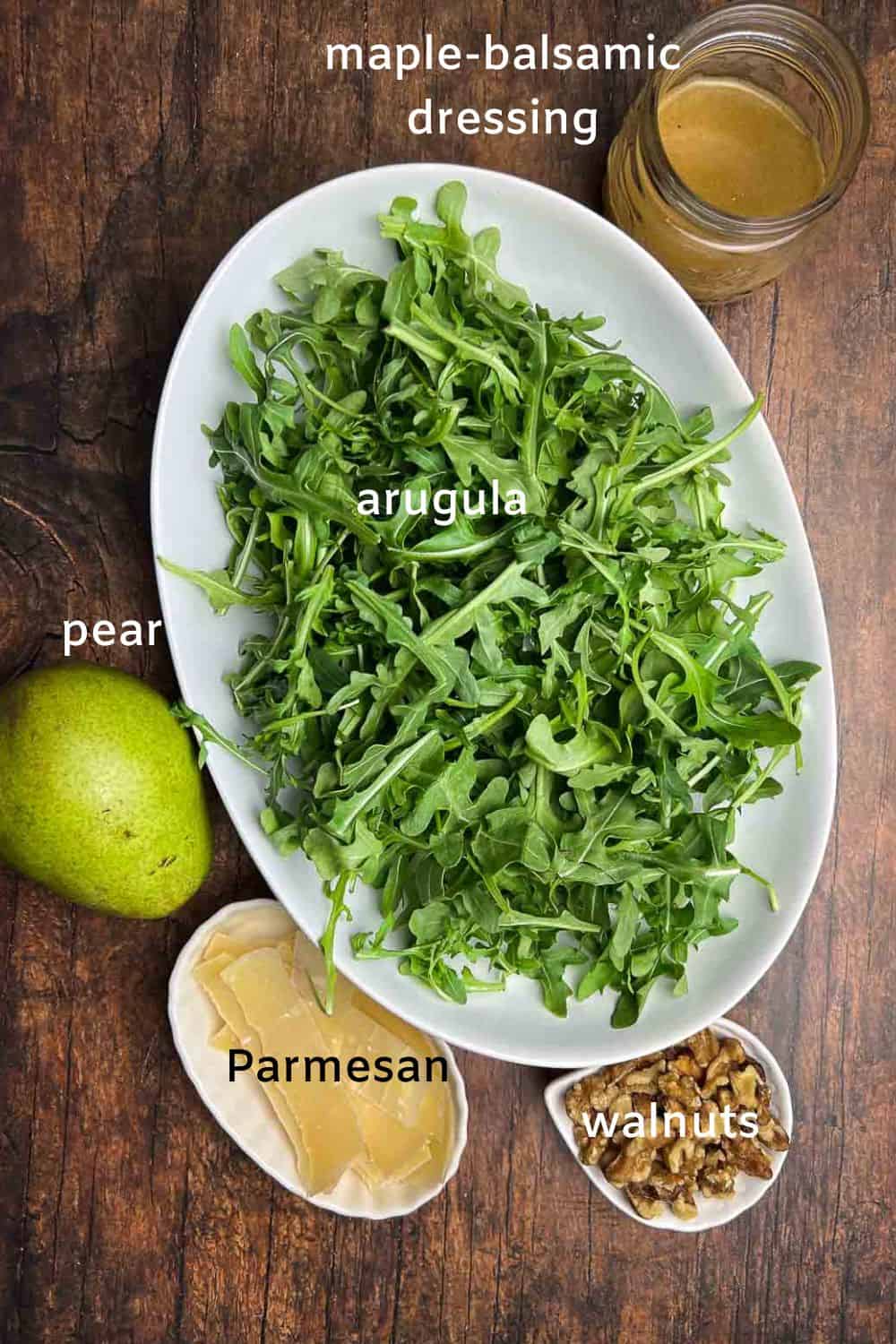 Ingredients for arugula salad with parmesan and pears.