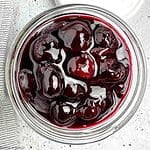 Overhead view of a jar of cherry sauce.