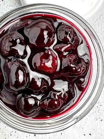 Overhead view of a jar of cherry sauce.