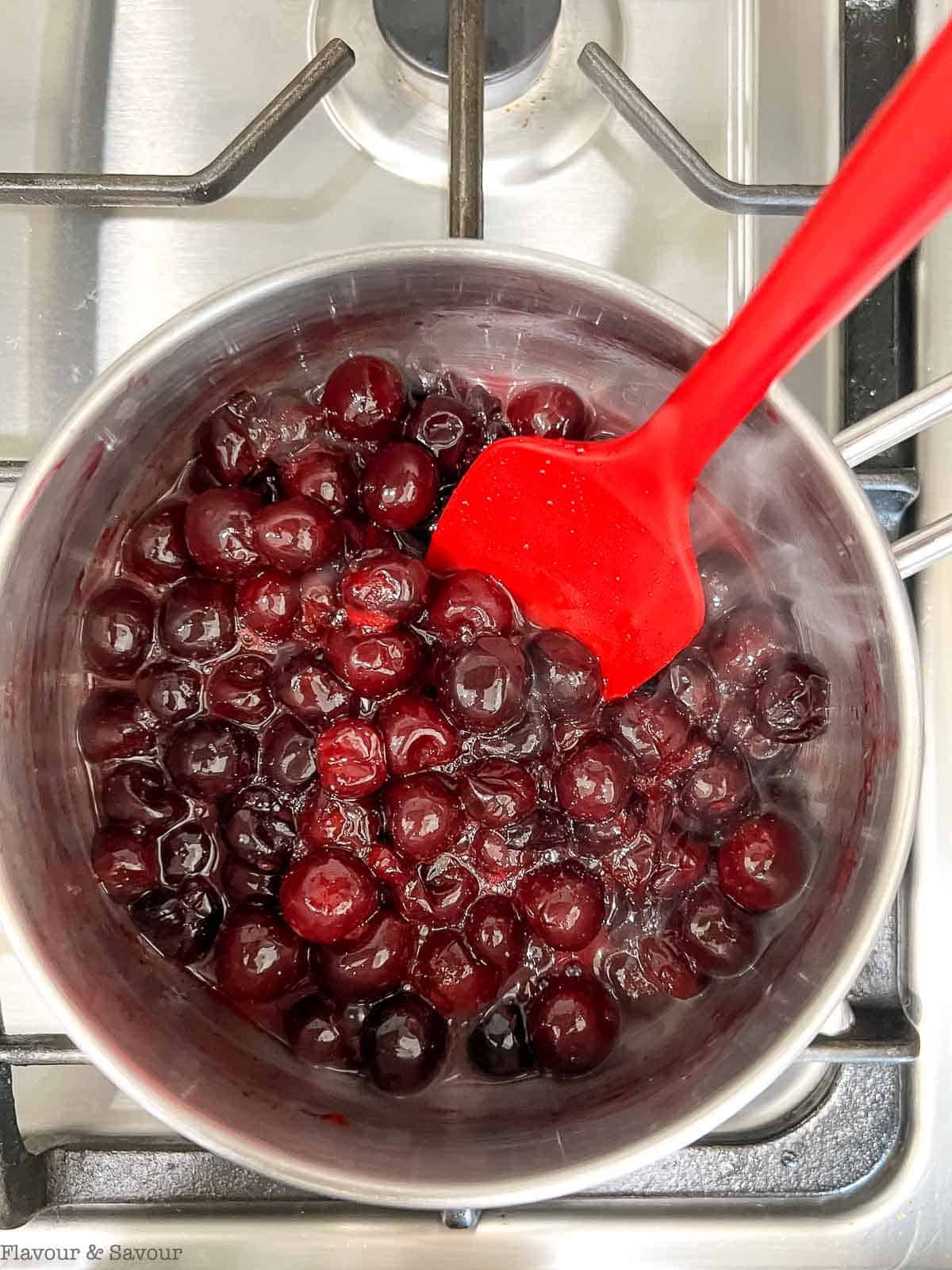 Cherry sauce boiling in a saucepan.