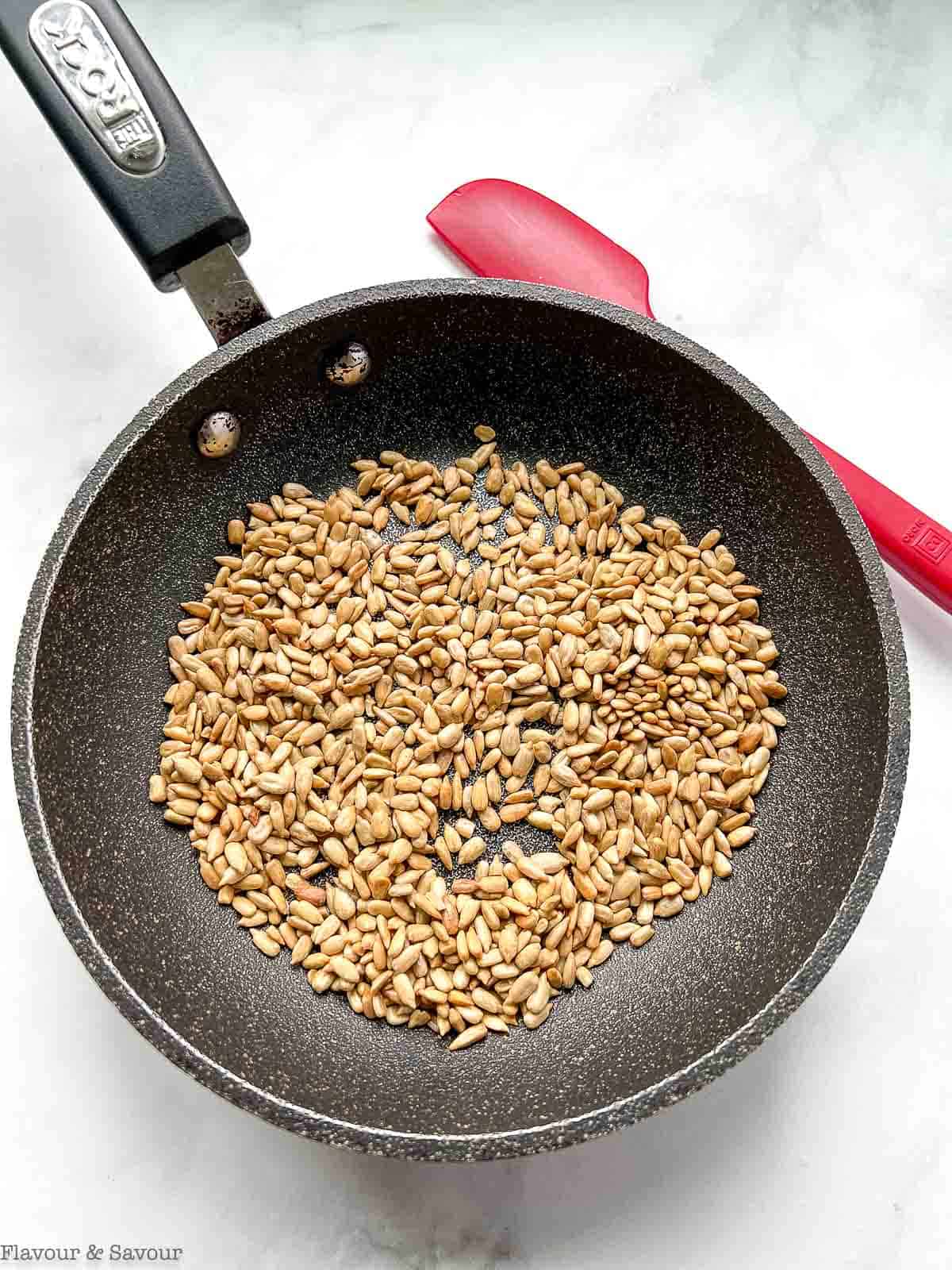 Sunflower seeds in a small skillet.