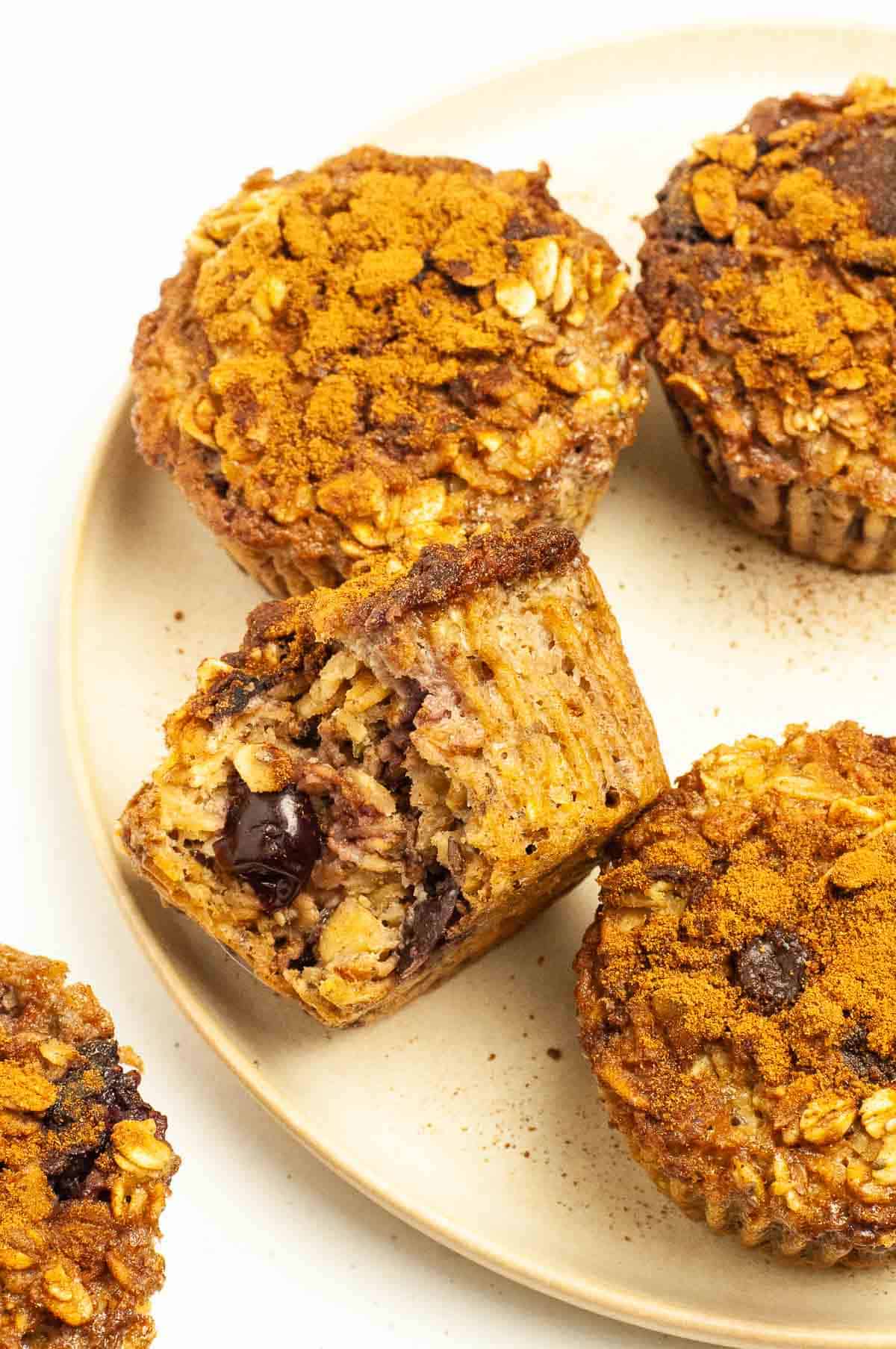 Baked oatmeal cups with cherries on a plate.