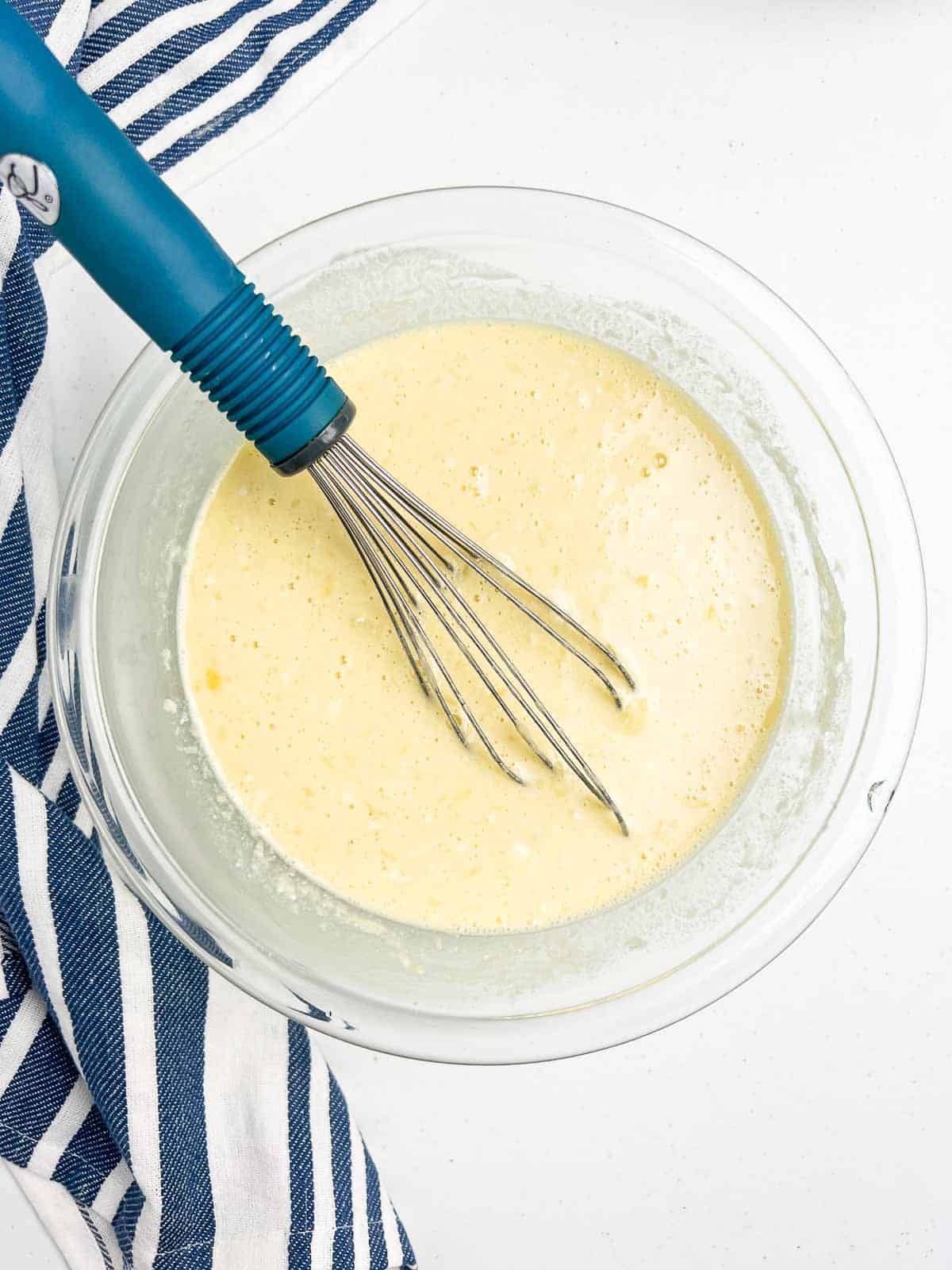 Whisking wet ingredients for cherry baked oatmeal batter.