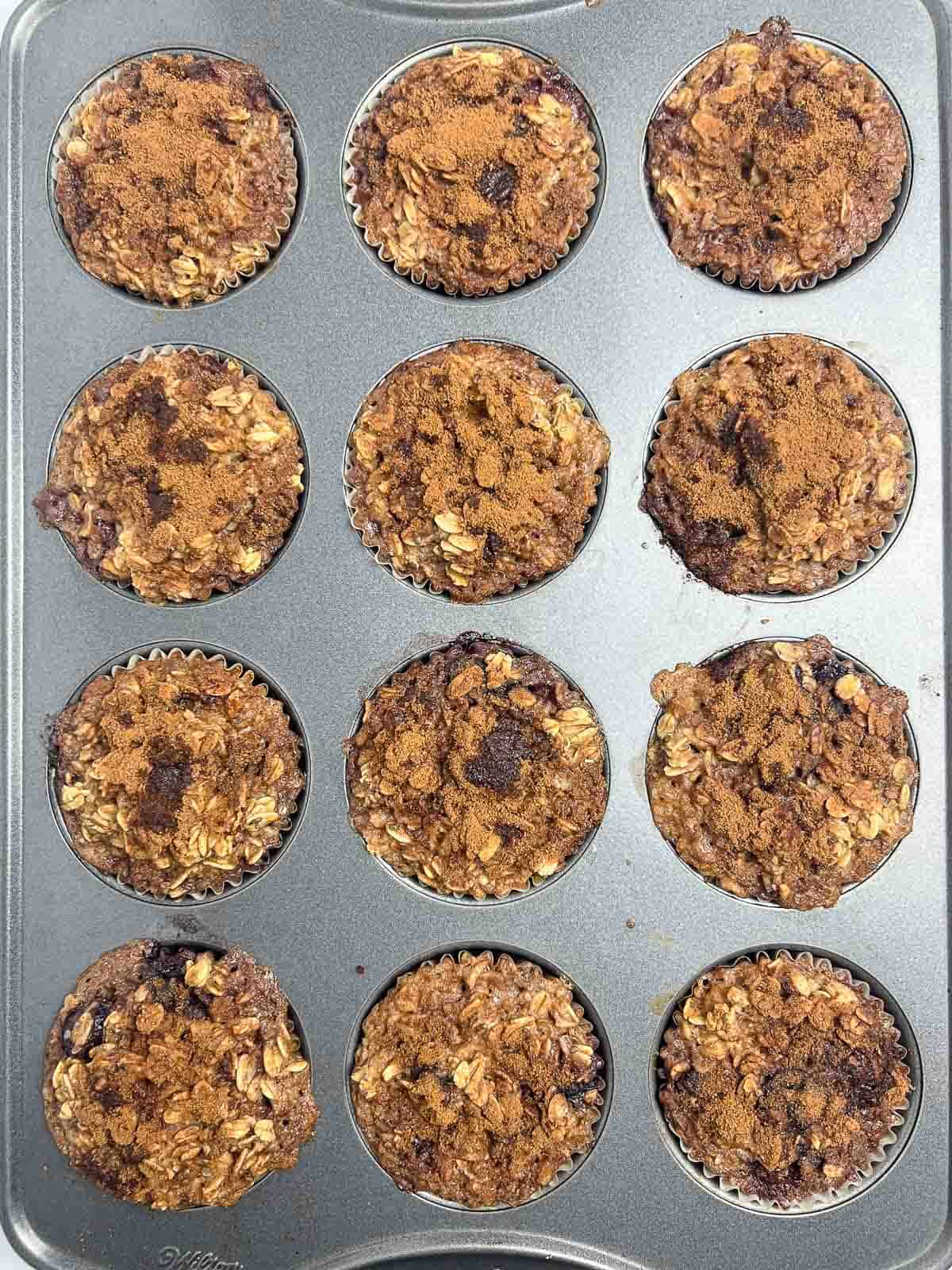 Cherry baked oatmeal cups fresh out of the oven in a muffin tin.