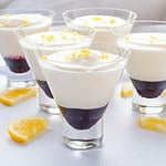 Lemon mousse with blueberry sauce in dessert glasses.