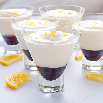 Lemon mousse with blueberry sauce in dessert glasses.