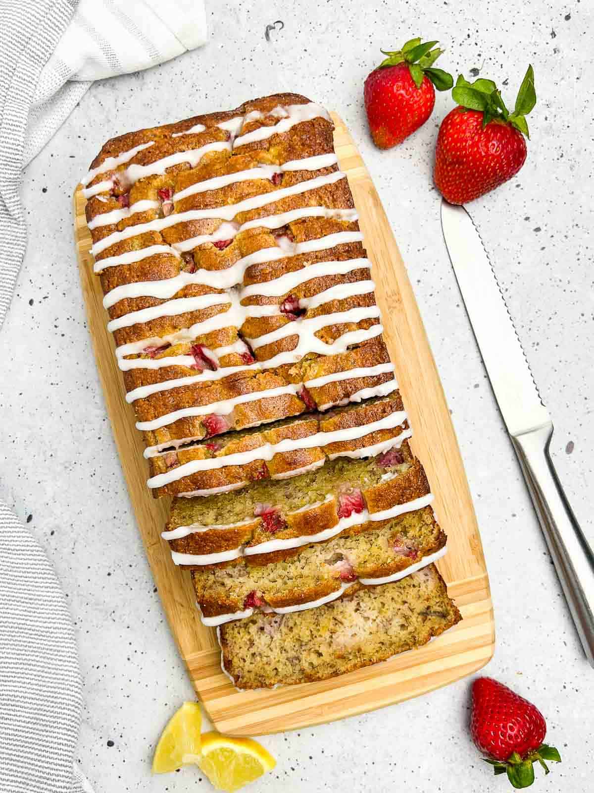 Overhead view of a loaf of almond flour banana bread with strawberries.