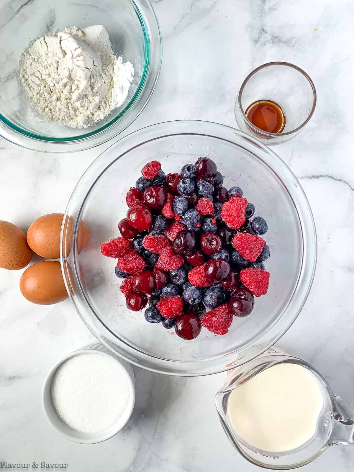 Ingredients for berry clafoutis with cherries.