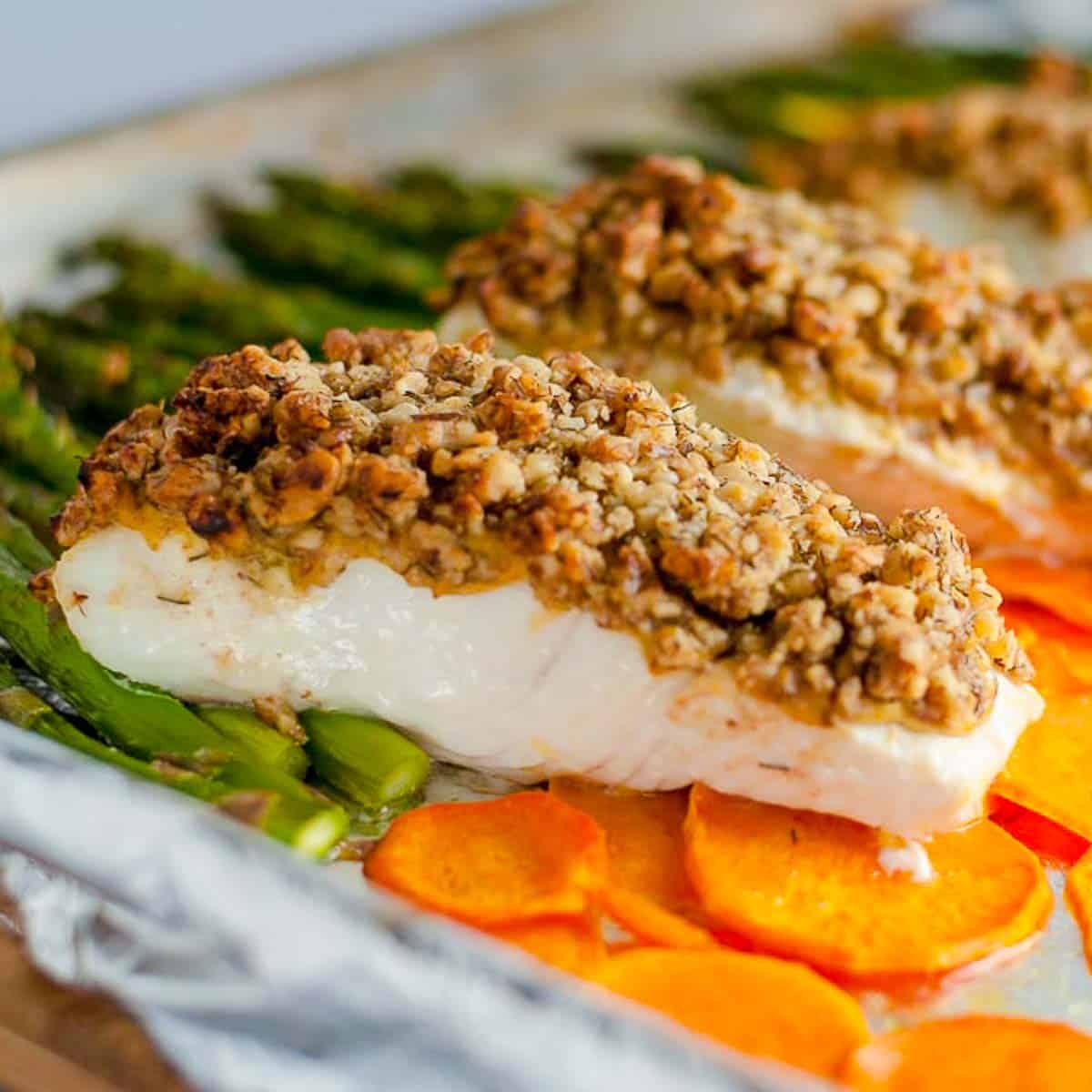 Close up view of a halibut fillet topped with maple walnut crust.