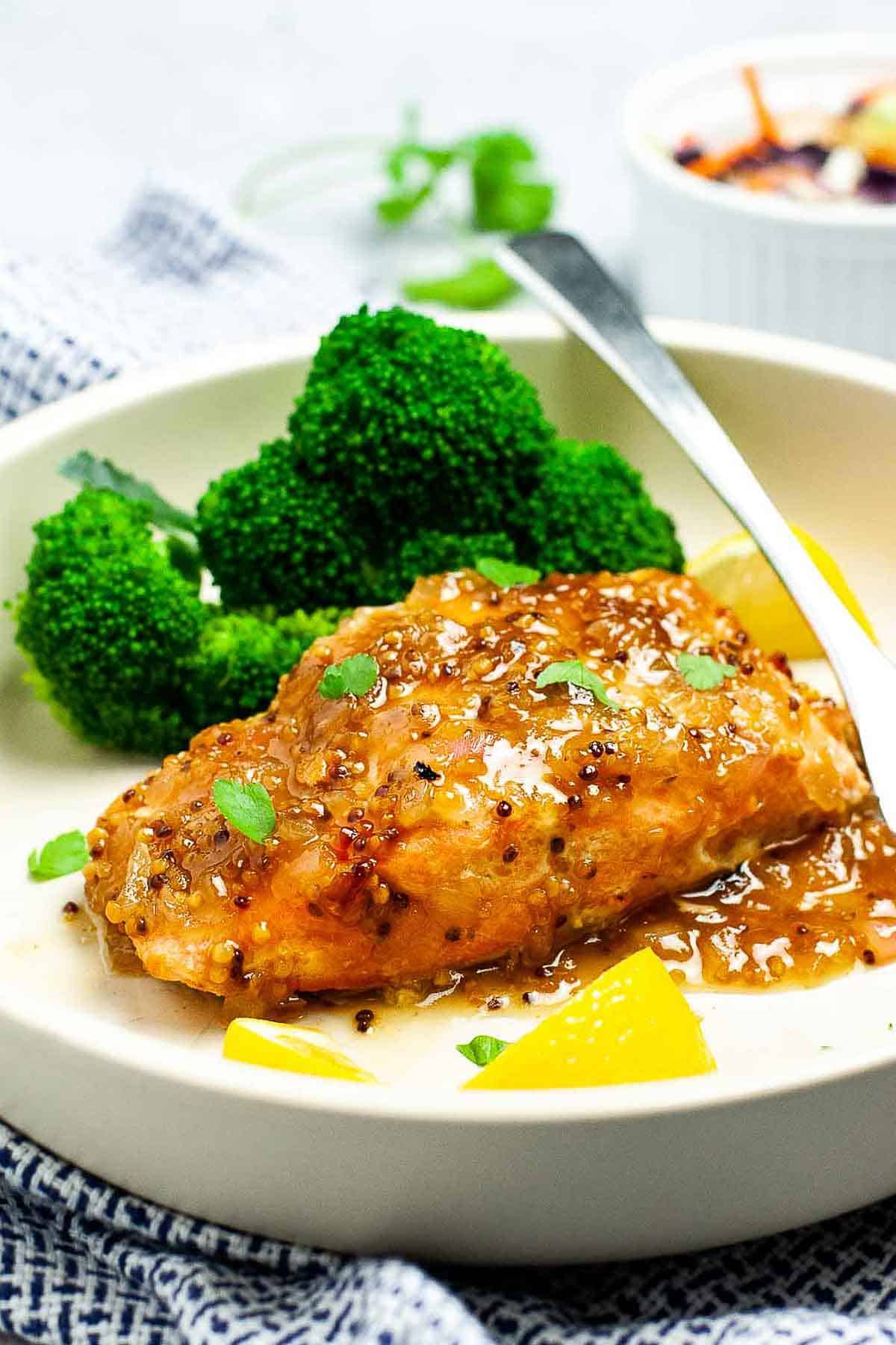 Honey-Dijon Glazed Salmon on a plate with broccoli.