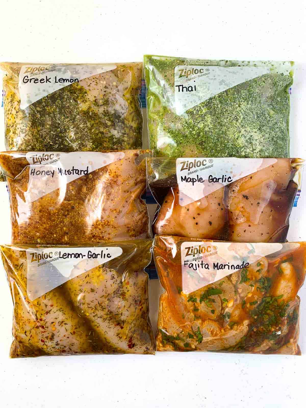 6 freezer bags with 6 different chicken marinades for gluten-free baked chicken recipes.