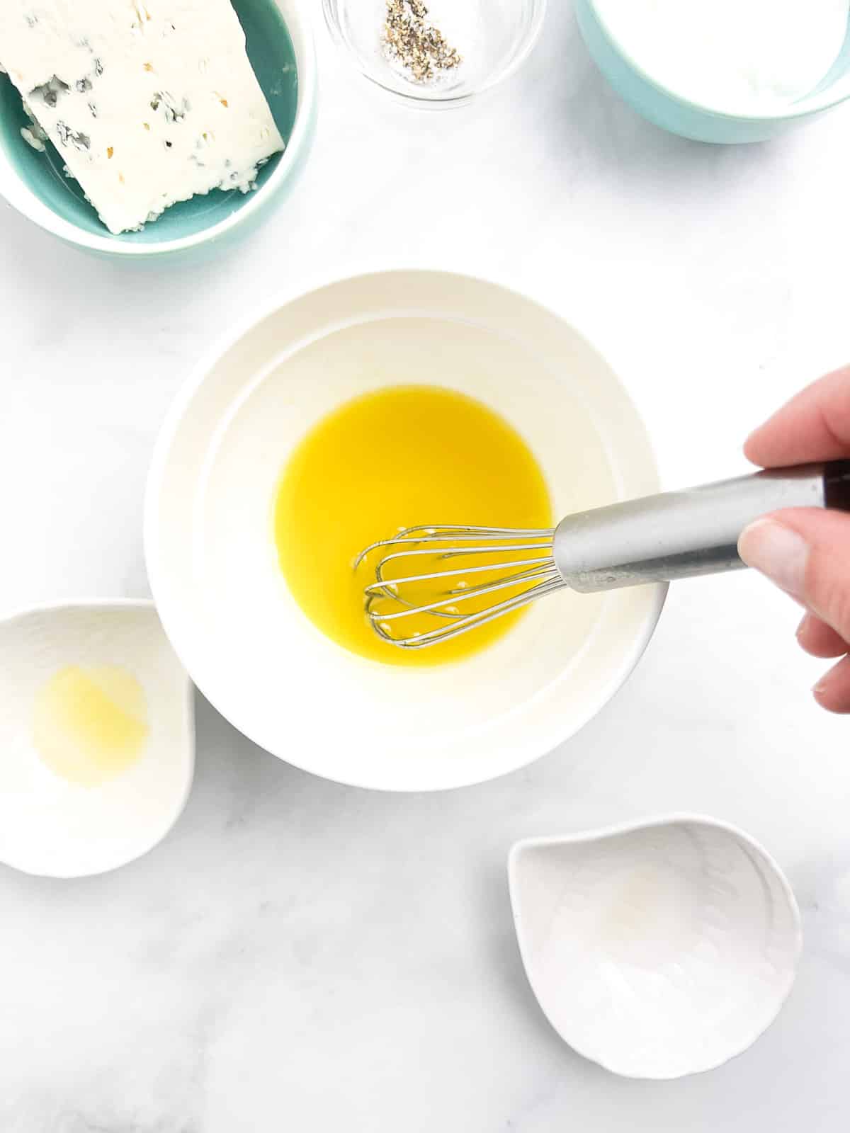 Whisk the olive oil and apple cider vinegar together.