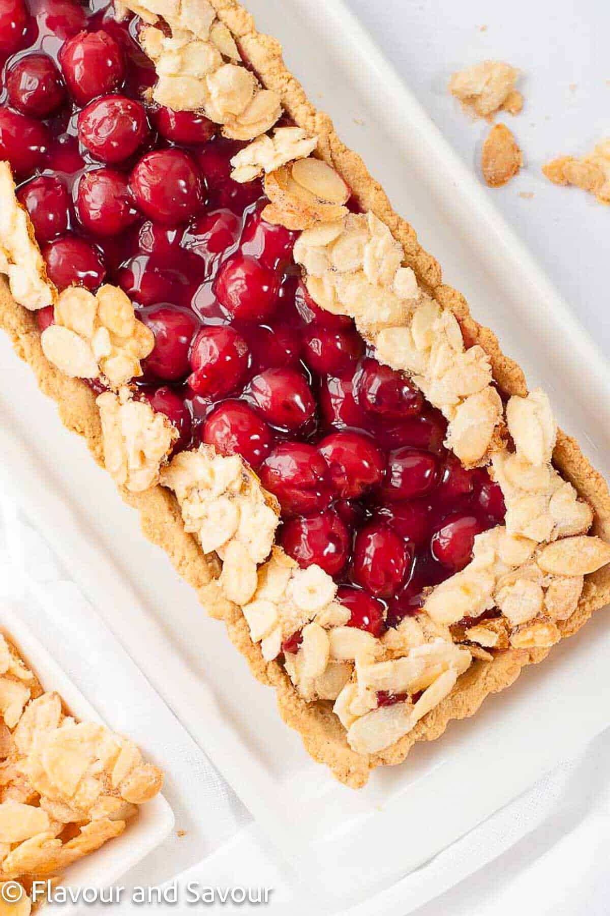 Close-up view of a sour cherry almond tart with a gluten-free crust.