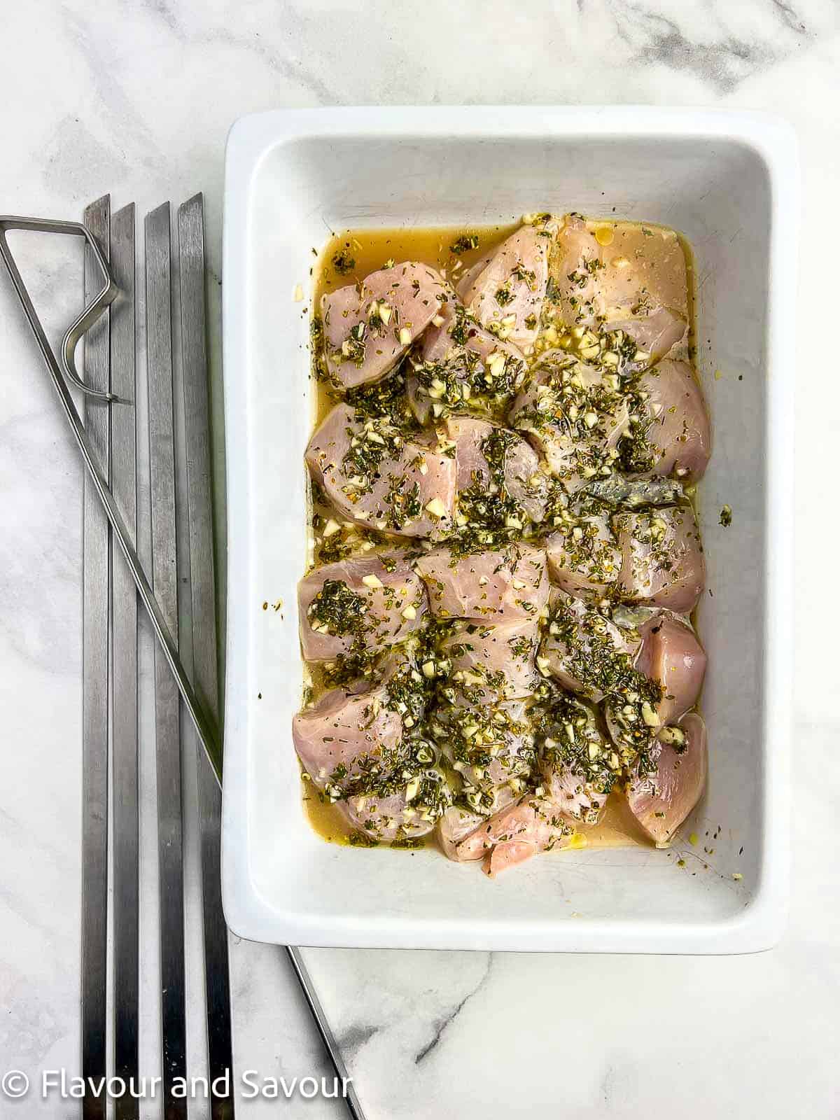 Chicken cubes in a lemon-garlic herb marinade.