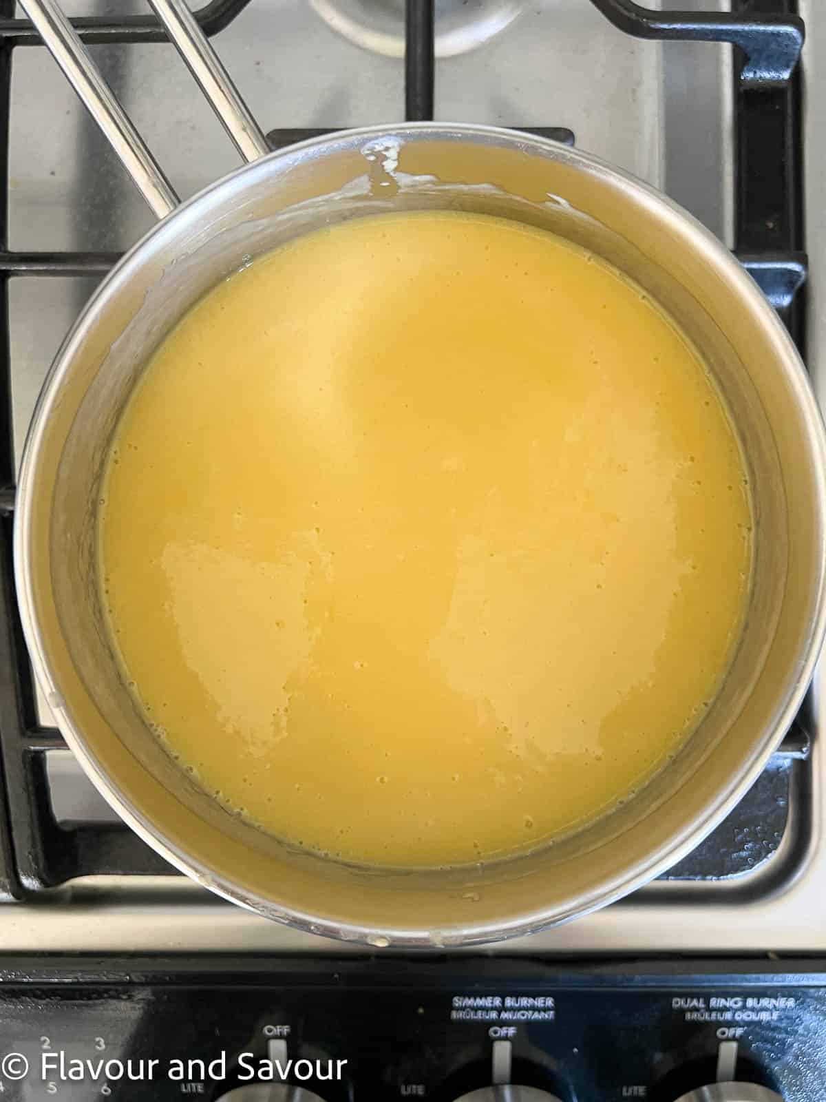 Gluten-free mango tart filling in a saucepan on the stove.