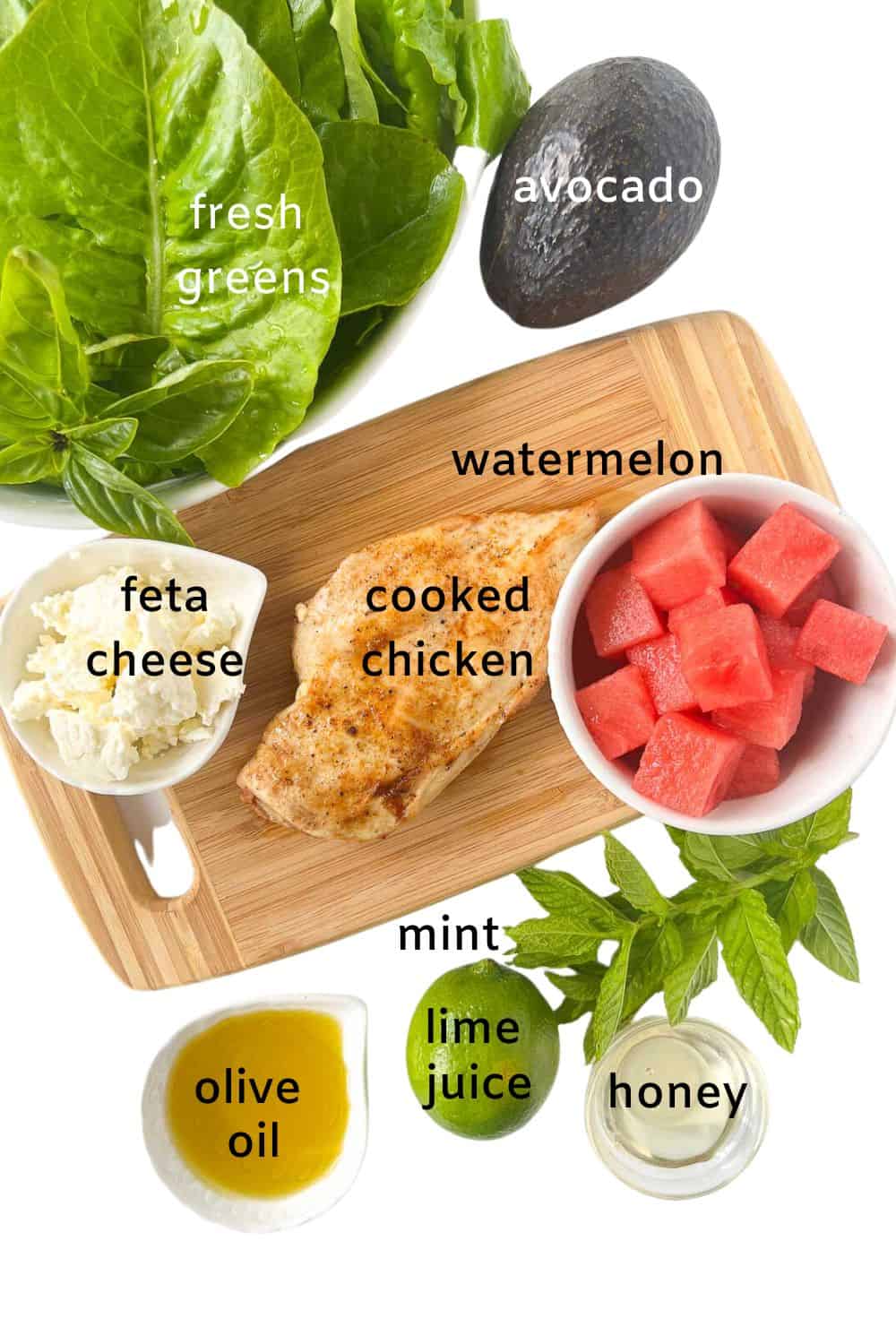 Ingredients for Avocado Chicken Salad: fresh greens, avocado, feta cheese, cooked chicken, watermelon cubes, olive oil, mint, lime juicy and honey.