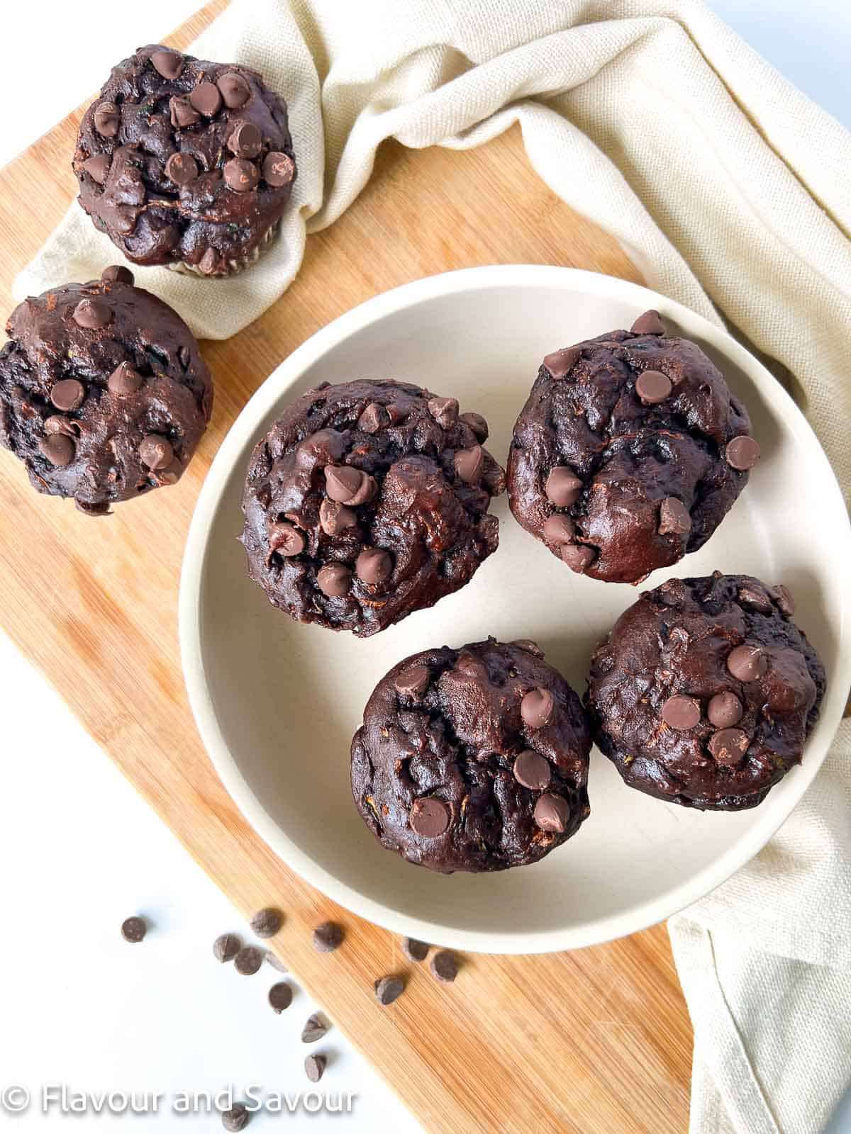 Overhead view of double chocolate zucchini muffins topped with extra chocolate chips.