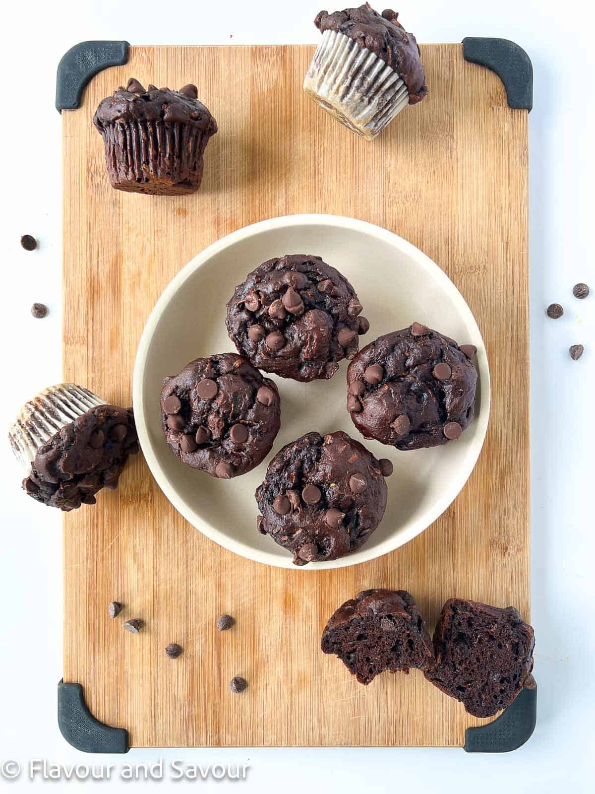 Gluten-free chocolate zucchini muffins on a board.