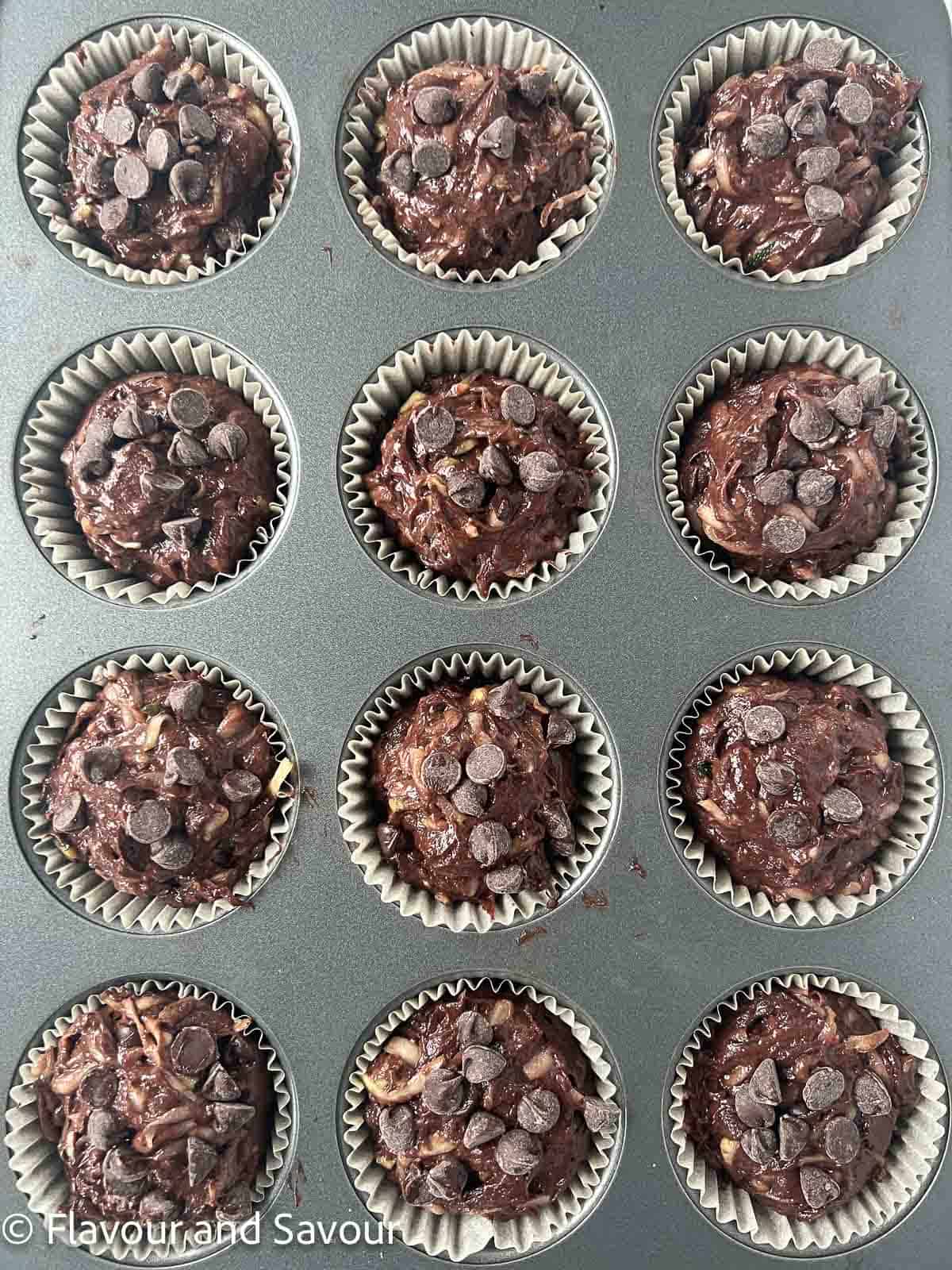 Chocolate zucchini muffins in a muffin pan.