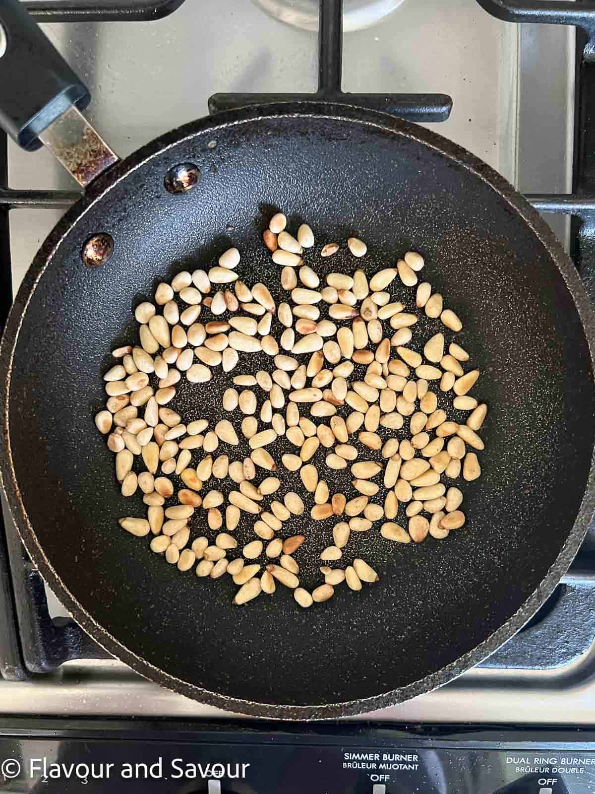 PIne nuts in a small skillet.