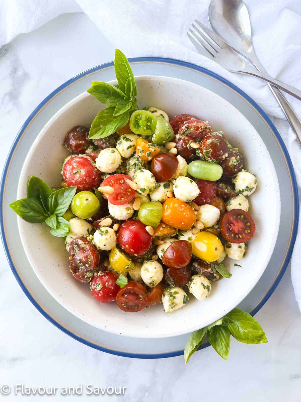 Pesto Caprese Salad with Cherry Tomatoes in a bowl without balsamic glaze.