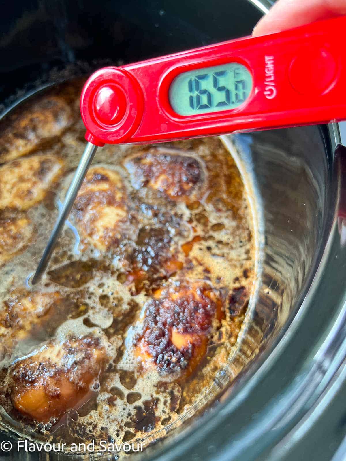 A meat thermometer showing 165°F.