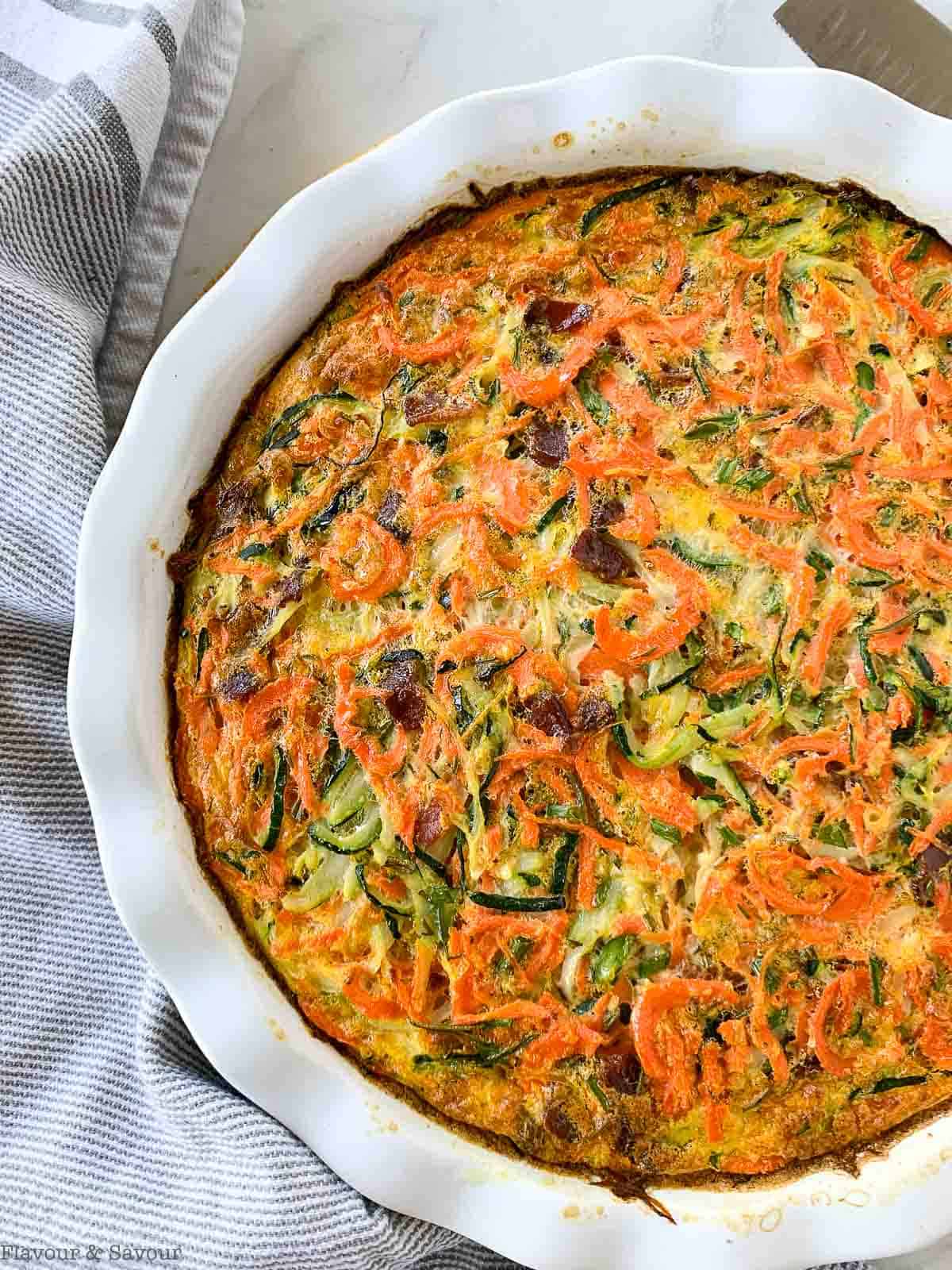 Closeup view of a baked zucchini carrot quiche.
